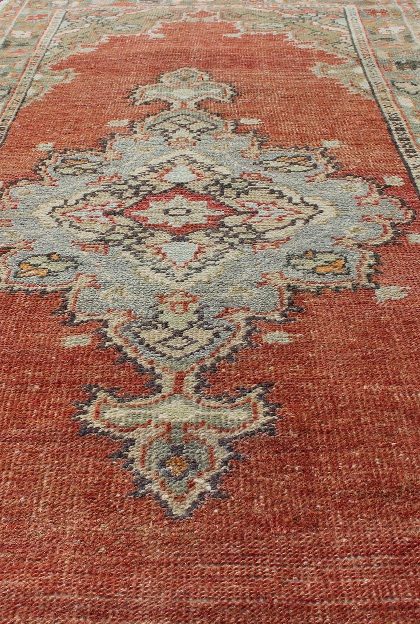 20th Century Vintage Turkish Oushak Rug with Layered Medallion on Soft Coral Color Background For Sale