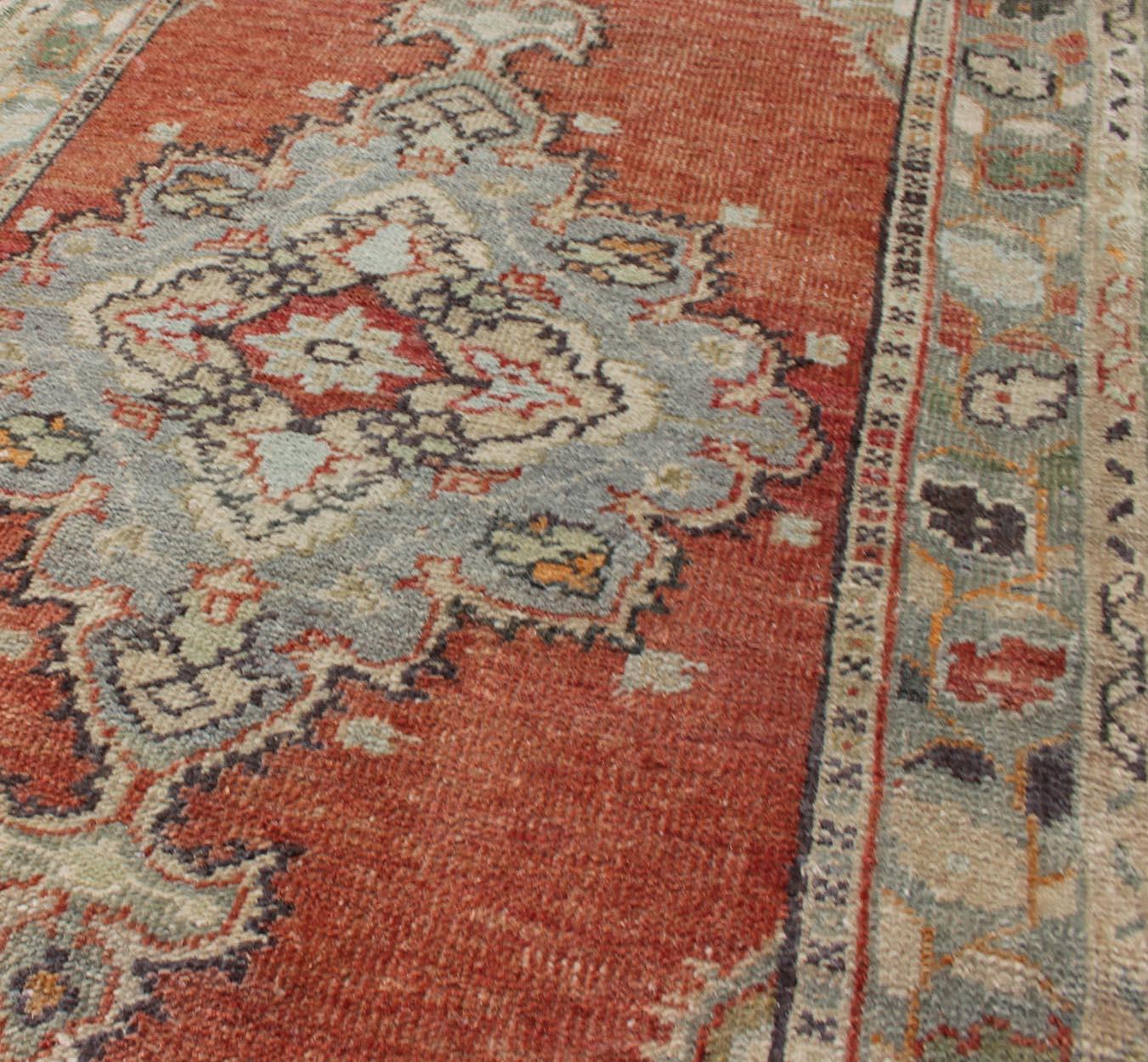 Wool Vintage Turkish Oushak Rug with Layered Medallion on Soft Coral Color Background For Sale