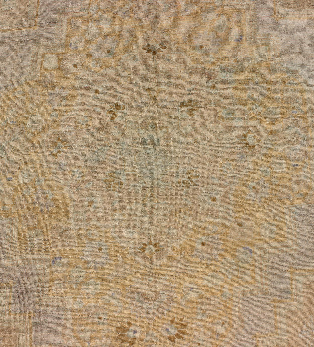Mid-20th Century Vintage Turkish Oushak Rug with Lightly Toned Medallion Design For Sale