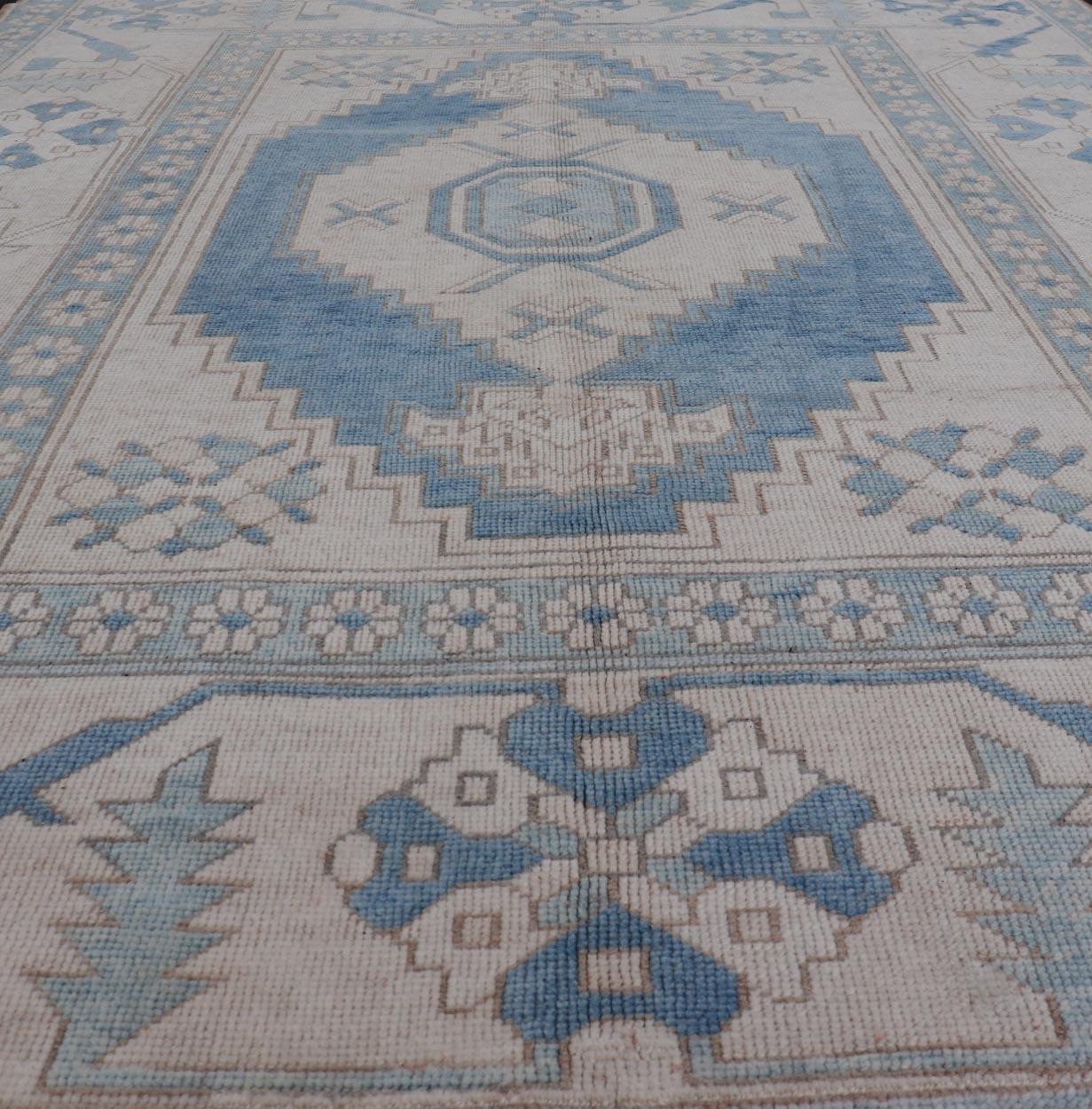 Oushak vintage rug from Turkey with Geometric medallion in various blue tones, Light teal blue and ivory, Keivan Woven Arts/rug TU-MTU-4954, country of origin / type: Turkey / Oushak, circa 1950. Vintage Turkish Rug, Blue rug Blue Turkish