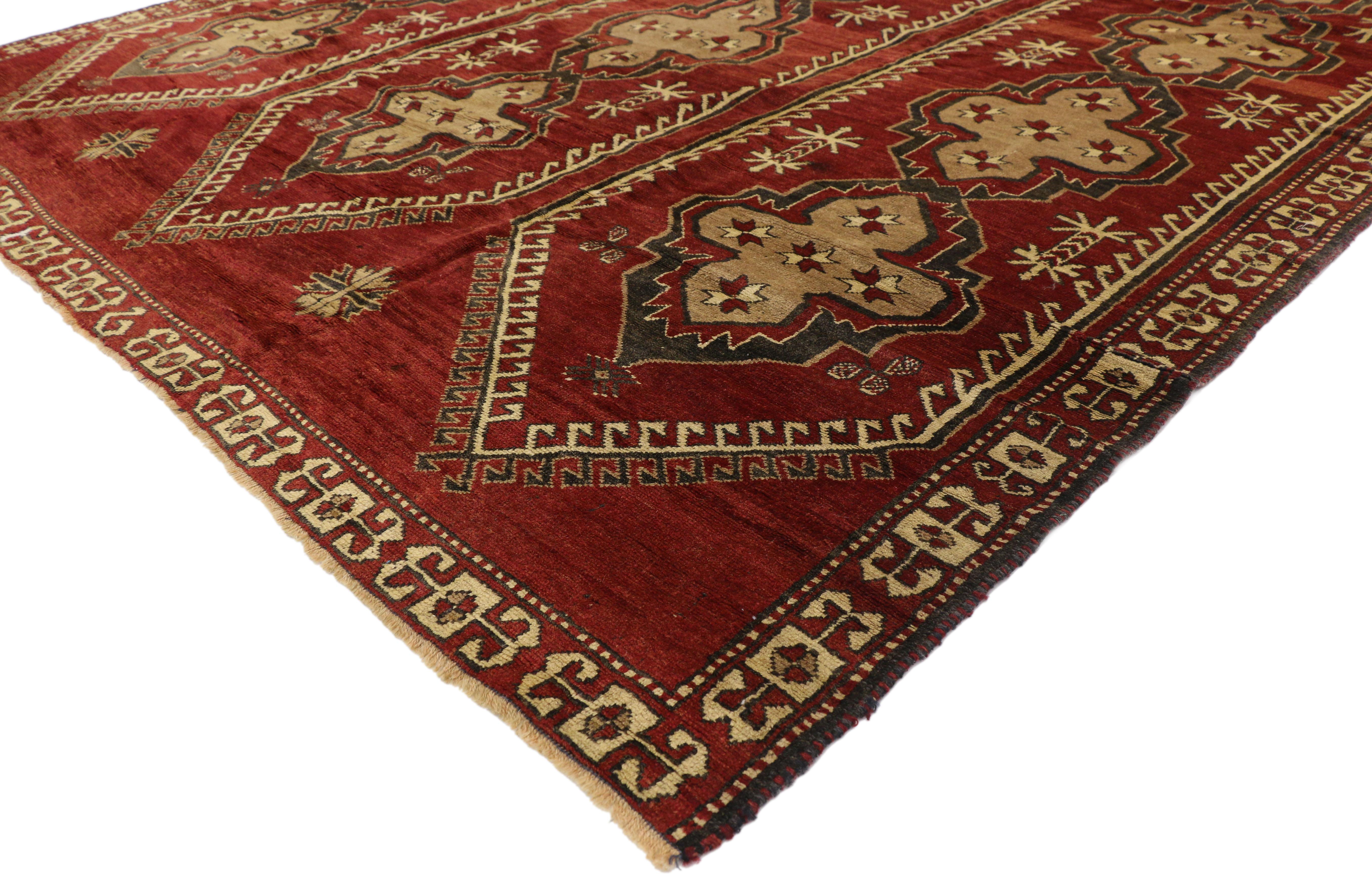 51442 Vintage Turkish Oushak Rug with Mid-Century Modern Style. This hand-knotted wool vintage Turkish Oushak rug features three vertical columns each filled with four cruciform cross-motifs dotted with ancient Anatolian symbols. The hexagonal