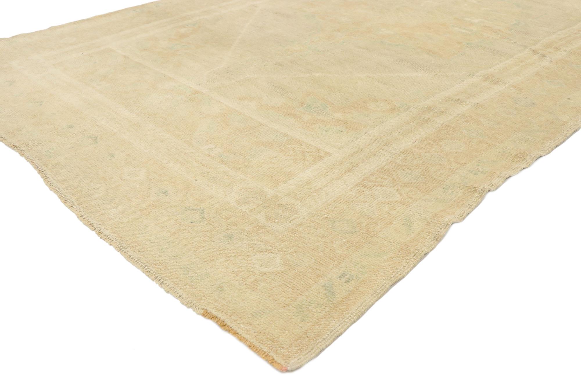 52974 vintage Turkish Oushak rug with Minimalist French Country Cottage style. Effortless beauty and soft, bespoke vibes meet Minimalist French Country Cottage style in this hand knotted wool vintage Turkish Oushak rug. The ecru-tan antique washed
