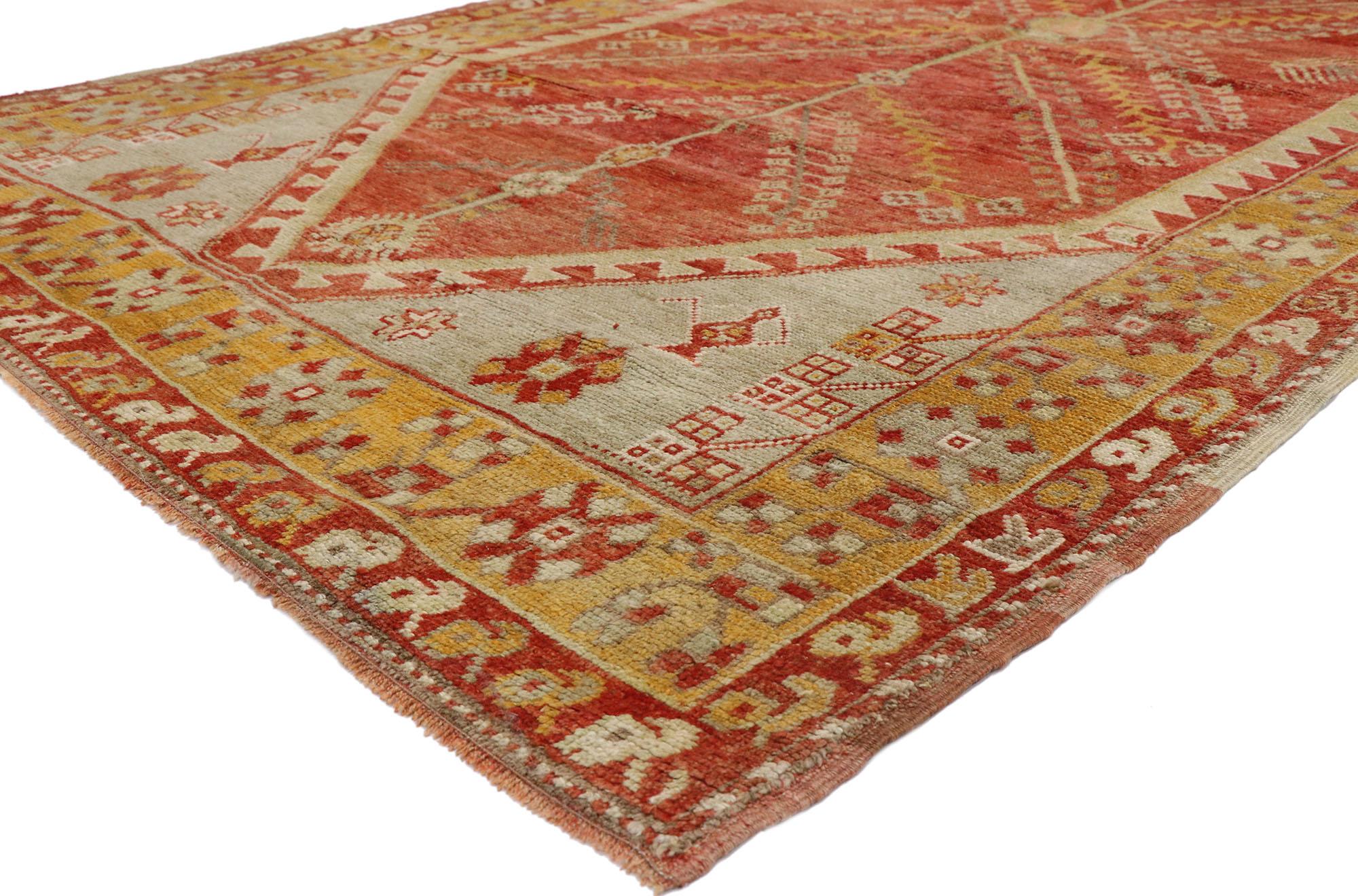 52752, vintage Turkish Oushak rug with Modern Northwestern Style 05'02 x 09'01. This hand knotted wool vintage Turkish Oushak rug features a pole medallion with extended tree of life symbols and comb motifs on an abrashed red field outlined with a