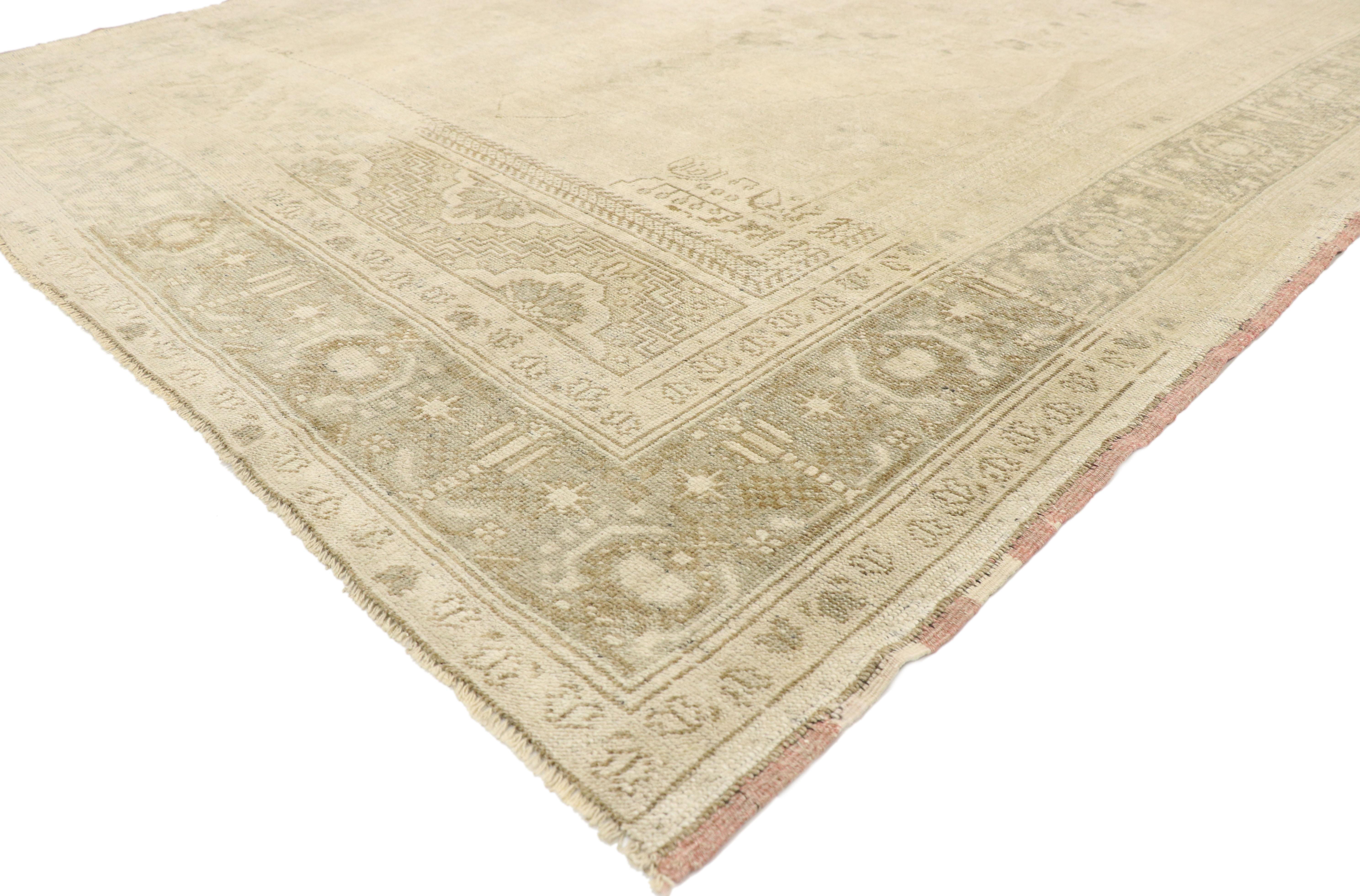 52834 Muted Vintage Turkish Oushak Rug, 06'05 x 11'01.
Emanating sophistication and grace, this hand knotted wool vintage Turkish Oushak rug provides an elegant and genteel design aesthetic with soft subtle hues. A cusped oval medallion with