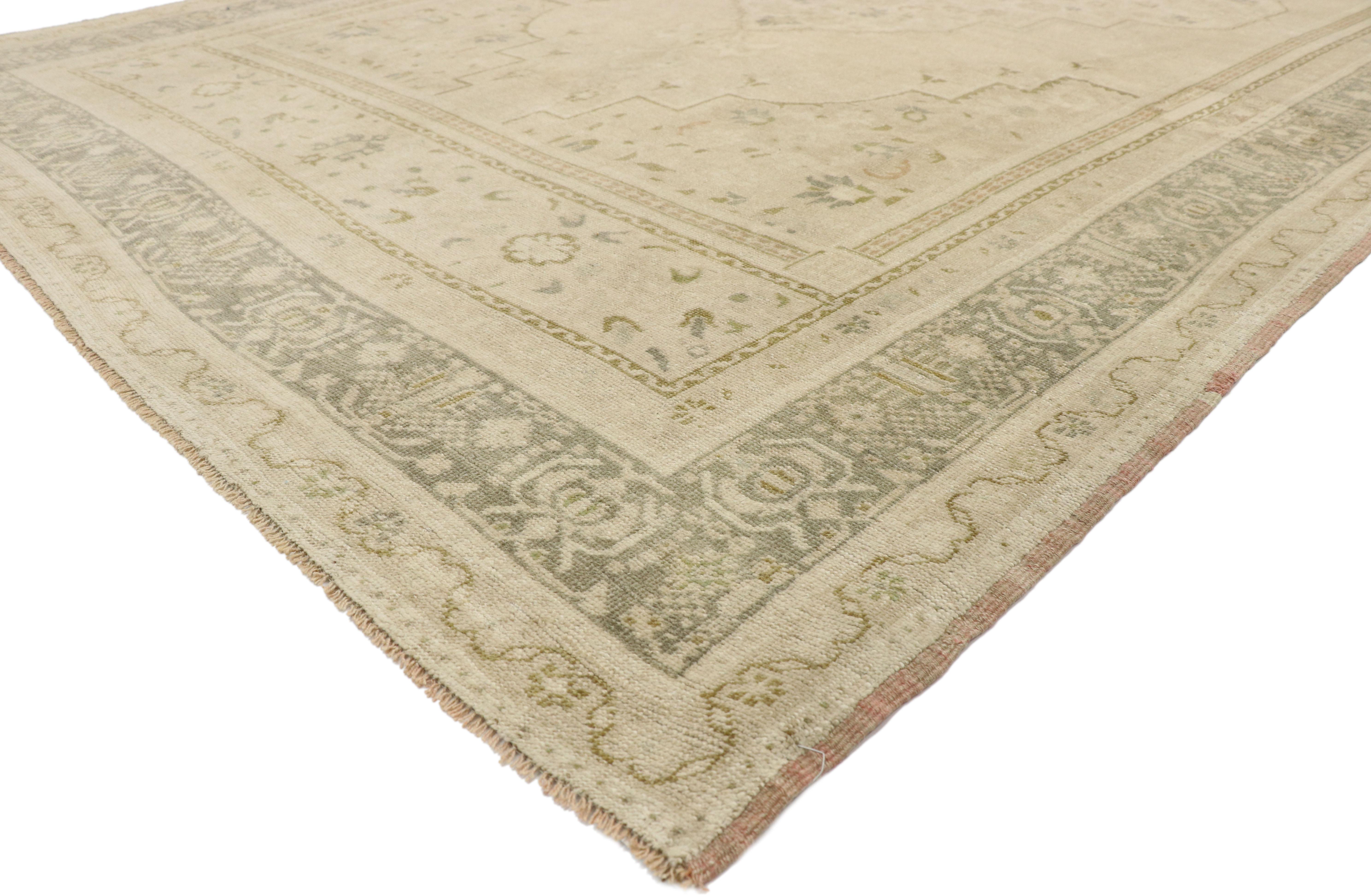 52833 Muted Vintage Turkish Oushak Rug, 07'05 x 13'08.
Easygoing elegance meets effortlessly chic in this hand knotted wool vintage Turkish Oushak rug. The faded botanical design and neutral earth-tone colors woven into this piece work together