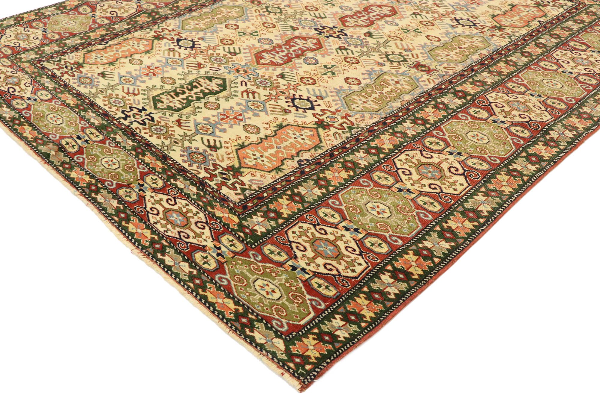 53070, vintage Turkish Oushak rug with modern Tribal style. Displaying well-balanced symmetry and a tribal design aesthetic, this hand knotted wool distressed vintage Turkish Oushak rug charms with ease. The abrashed beige field features an all-over