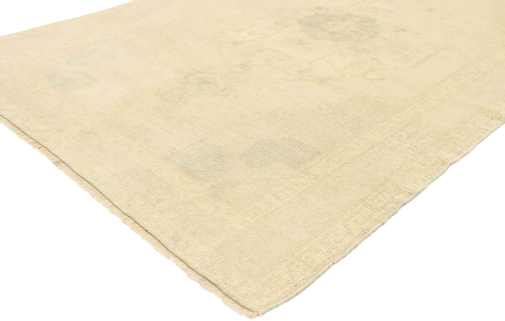 52971, vintage Turkish Oushak rug with Monochromatic Minimalist International style. Soft, bespoke vibes and simplicity meet effortless beauty in this hand knotted wool vintage Turkish Oushak rug. The antique washed field displays a daintily woven