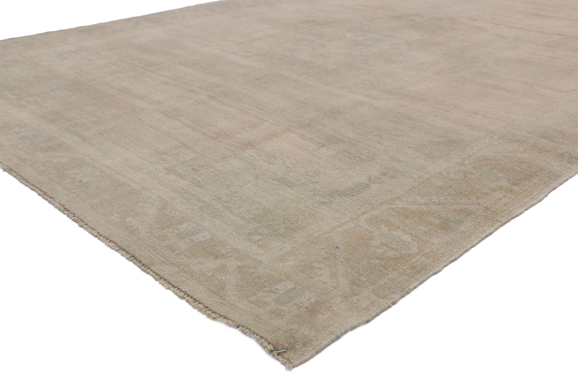 52458, vintage Turkish Oushak rug with Monochromatic Mission style and feminine tones. This hand knotted wool vintage Turkish Oushak rug features an ethereal cusped medallion in an abrashed field. It is enclosed with subtle spandrels in each corner