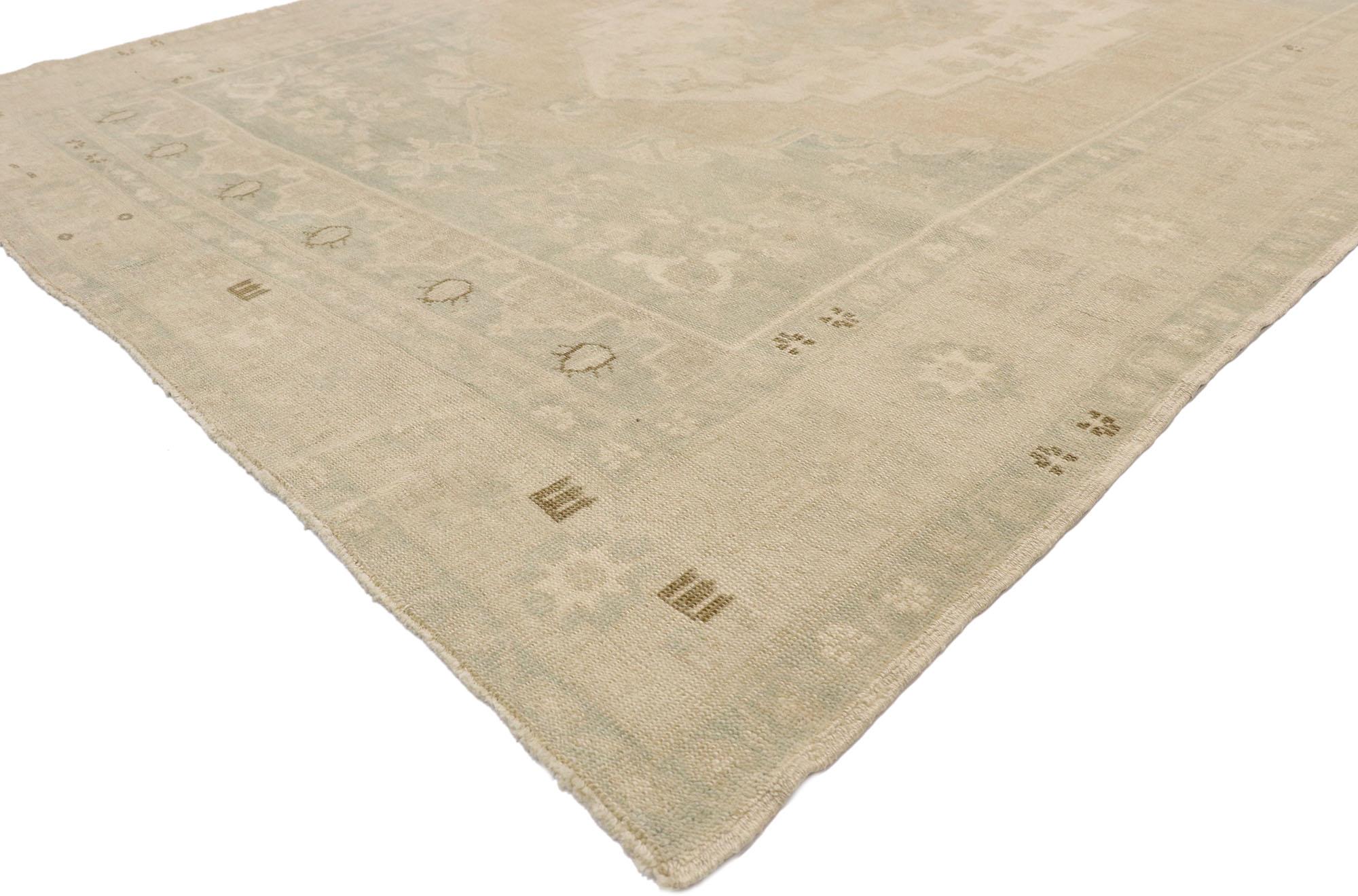 52809 Muted Vintage Turkish Oushak Rug, 06'02 x 09'01.
Subtle sophistication meets nostalgic charm in this hand knotted wool vintage Turkish Oushak rug. The faded botanical design and neutral earth-tone colors woven into this piece work together