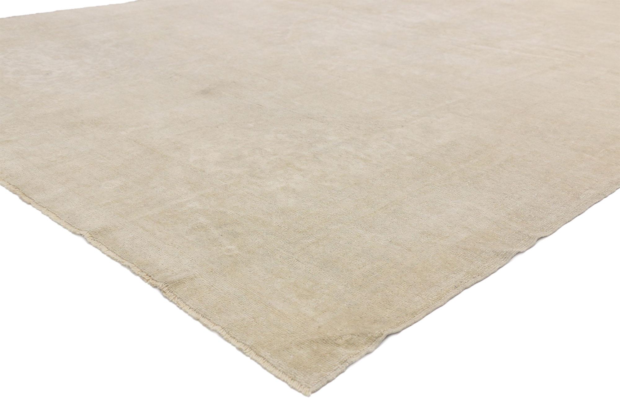 52494, vintage Turkish Oushak rug with Monochromatic Mission style and soft subtle hues. This hand knotted wool vintage Turkish Oushak rug features an oval medallion outlined in an ethereal scalloped edge floating in an abrashed field. It is