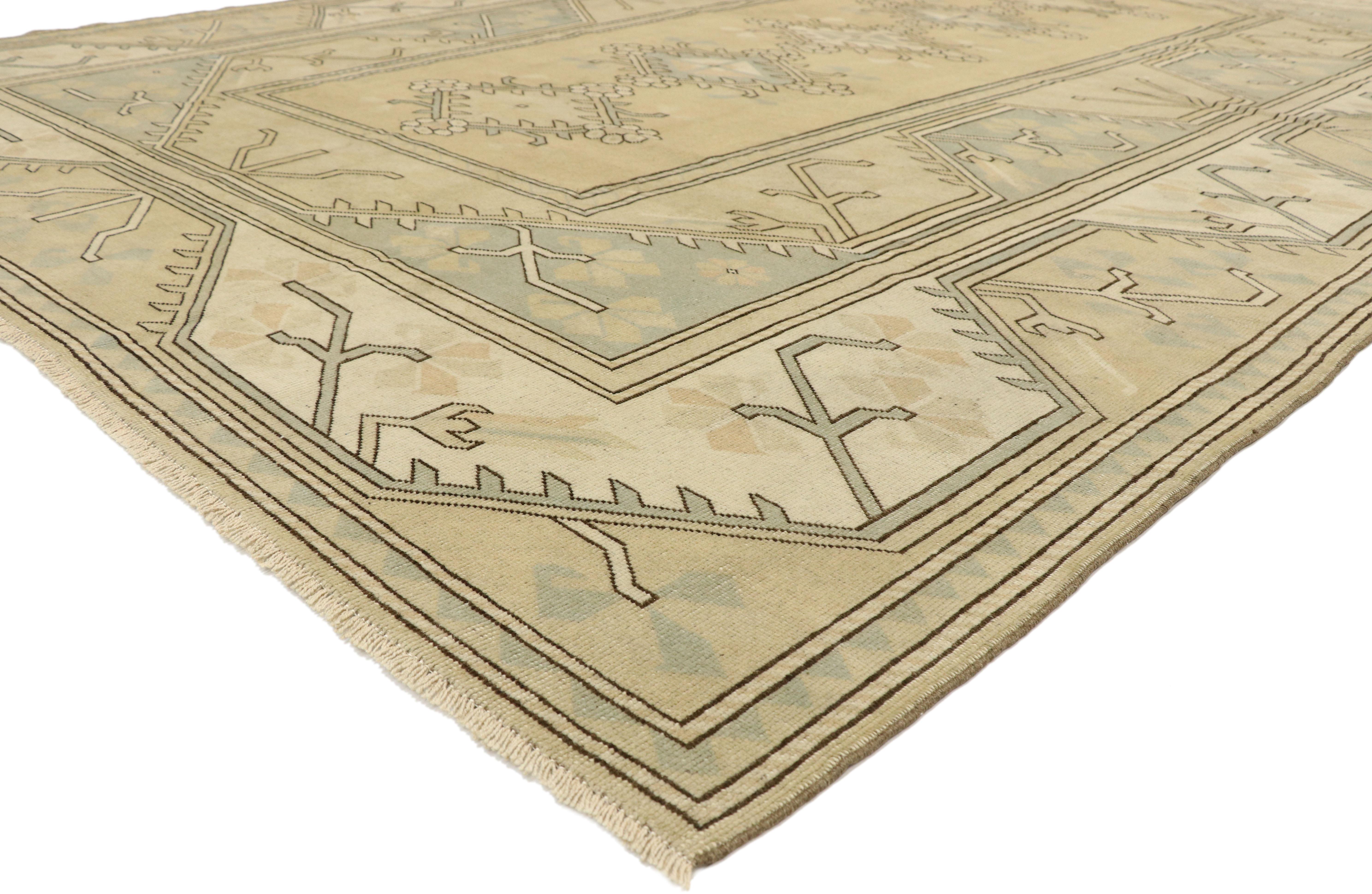 51849 Vintage Turkish Oushak Rug 08'10 x 11'08. Full of tiny details and an expressive design, this hand-knotted wool vintage Turkish Oushak rug is a captivating vision of woven beauty. The khaki colored field features five botanical lozenge