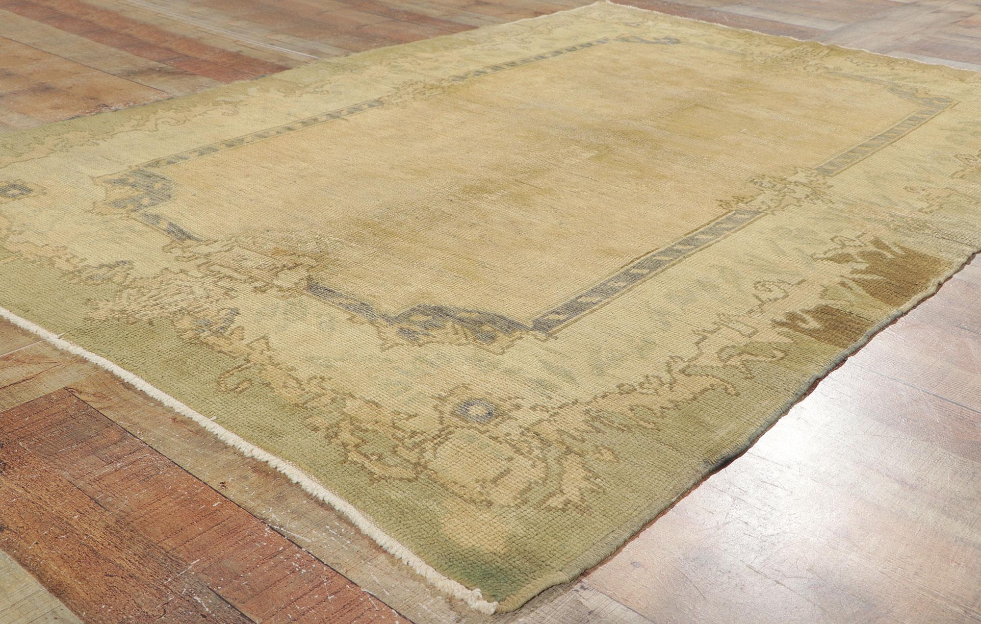 Wool Vintage Turkish Oushak Rug with Muted Earth-Tone Colors For Sale