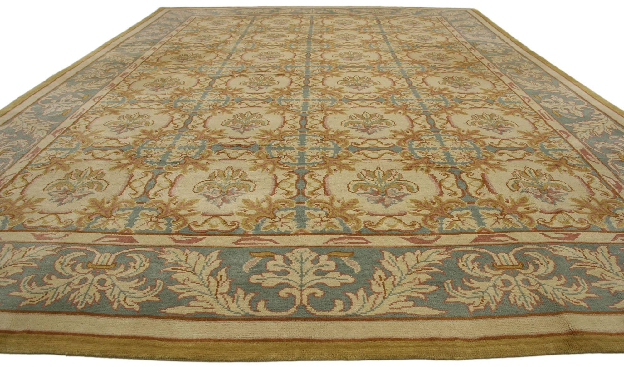 77121 Vintage Turkish Oushak Rug with Neoclassical European Style and Soft Colors. This hand knotted wool vintage Turkish Oushak rug features an all-over trellis pattern composed of offset rows of rounded floral motifs spread across an abrashed
