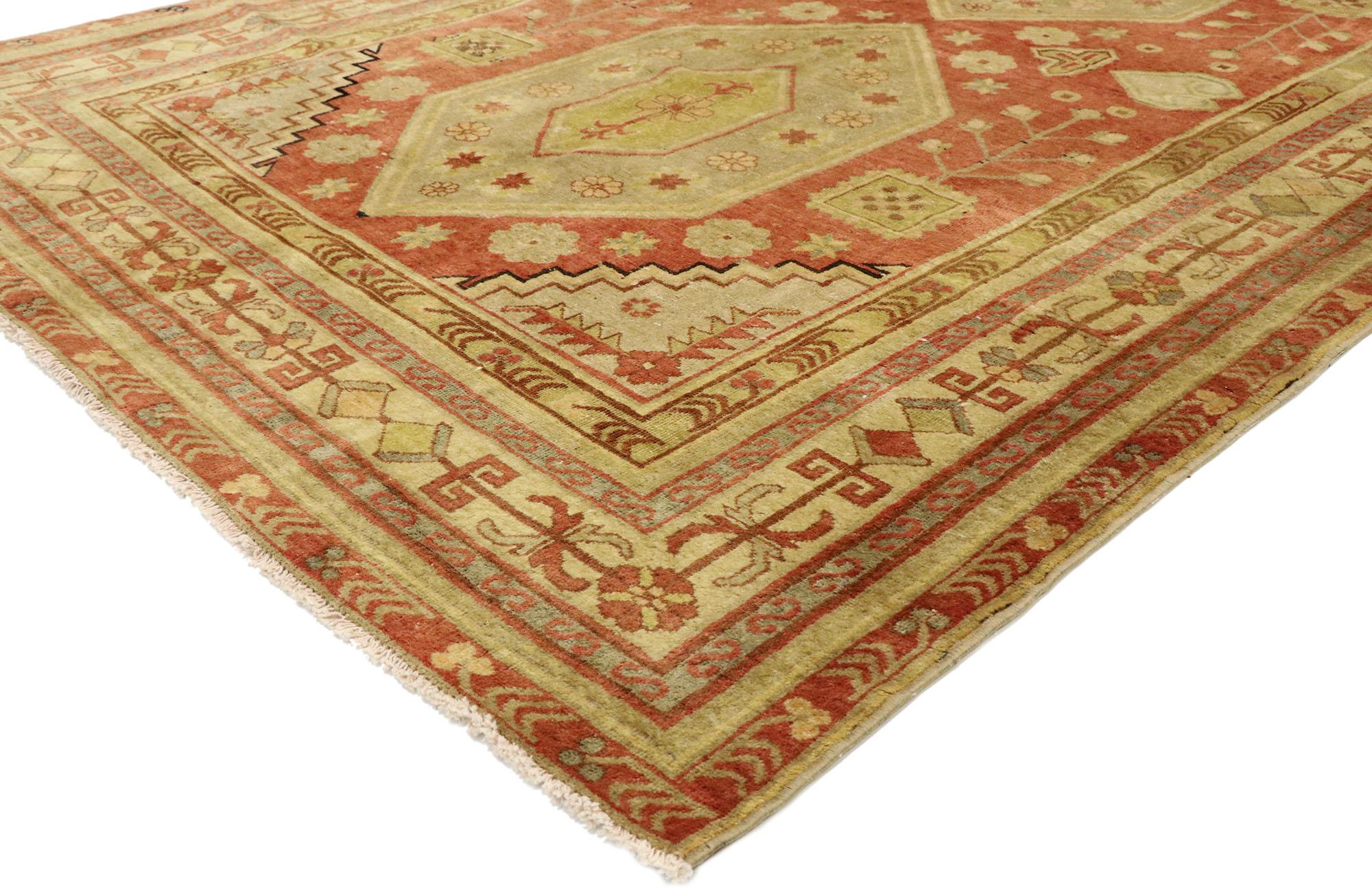 53044, vintage Turkish Oushak rug with Northwestern Tribal style. Rustic sensibility and down-to-earth vibes meet Northwestern tribal style in this hand knotted wool vintage Turkish Oushak rug. The abrashed red field features two concentric