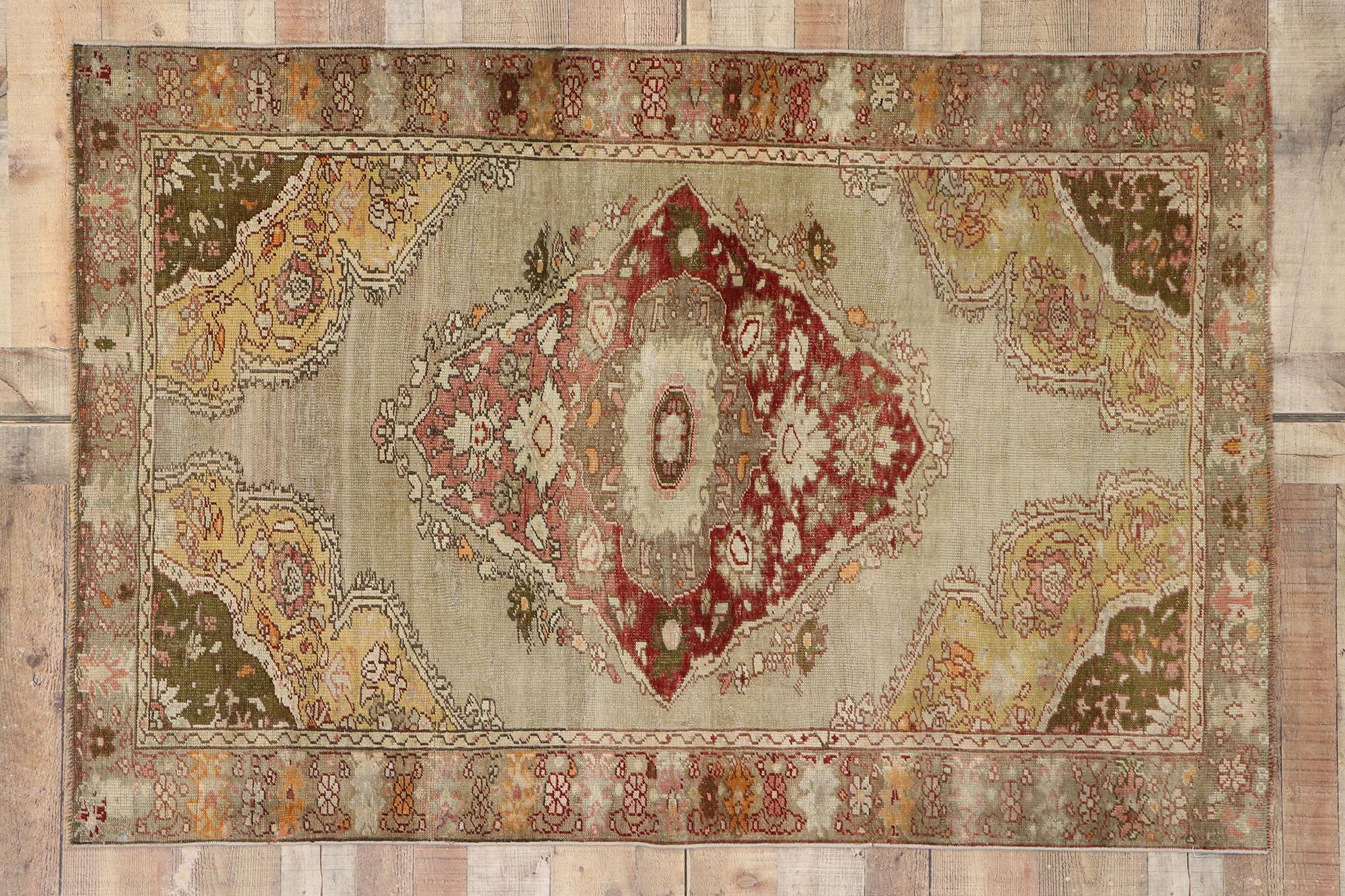 53273 vintage Turkish Oushak rug with Romantic Arts & Crafts style. This hand knotted wool vintage Turkish Oushak rug features a diamond-shaped medallion floating on an abrashed warm brown-taupe field. A delicate floral garland elegantly runs along