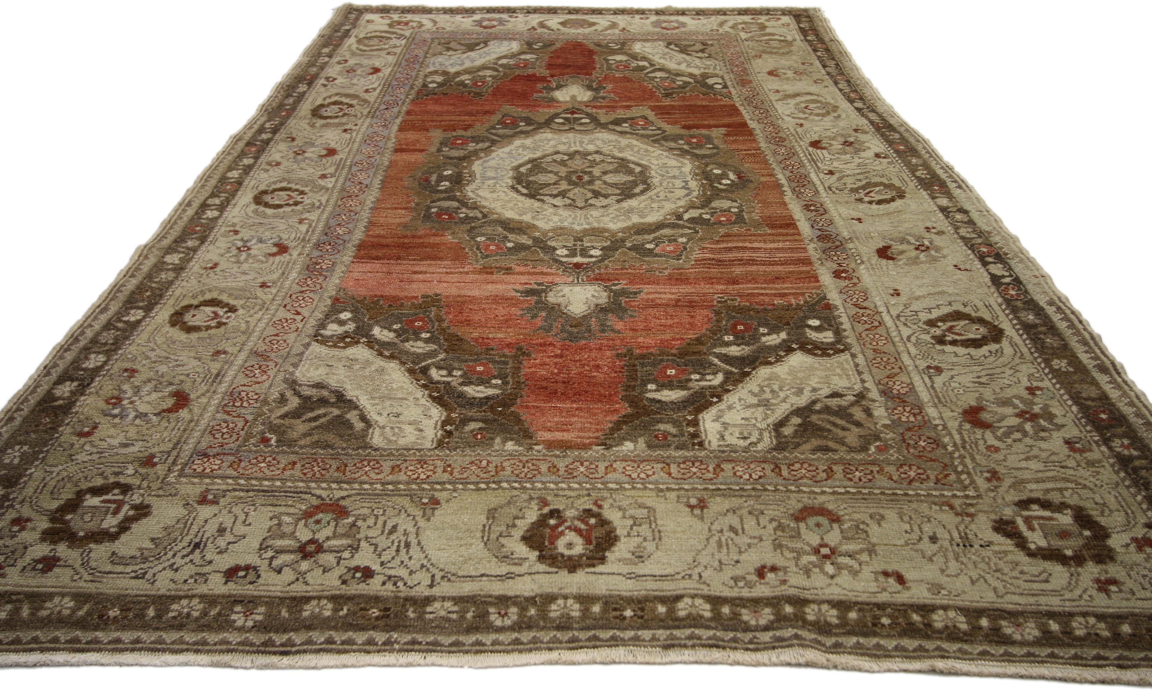 50756, vintage Turkish Oushak rug with rustic Artisan Bohemian style. This hand knotted wool vintage Turkish Oushak rug features a large lobed medallion with palmette pendants floating on a heavily abrashed brick red field. Corresponding quarter