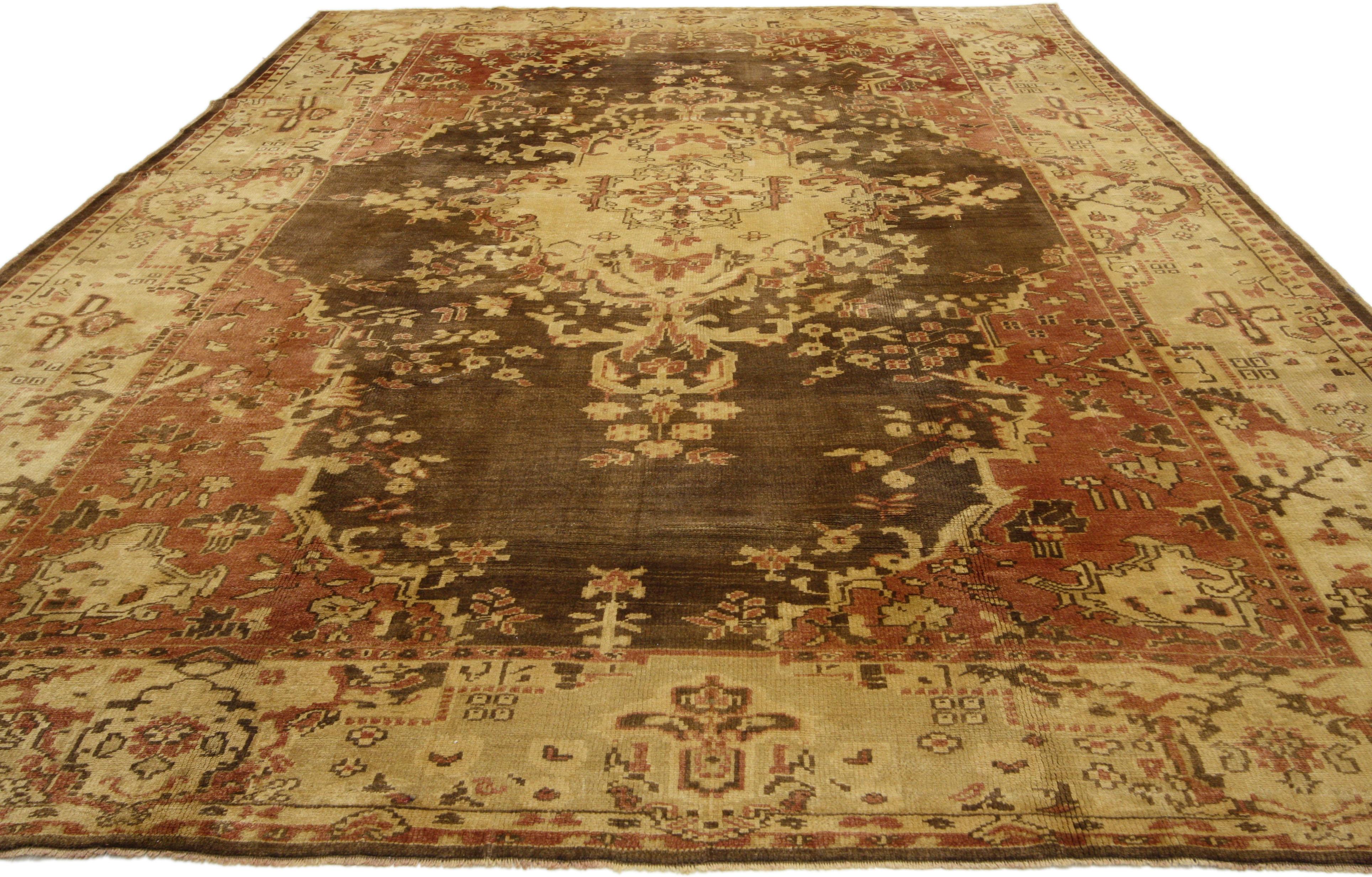 50561 Vintage Turkish Oushak rug with Rustic Arts & Crafts style. This hand knotted wool vintage Turkish Oushak rug features a large-scale medallion composed of leafy tendrils, delicate millefleurs, and roundel florals. The medallion floats in an