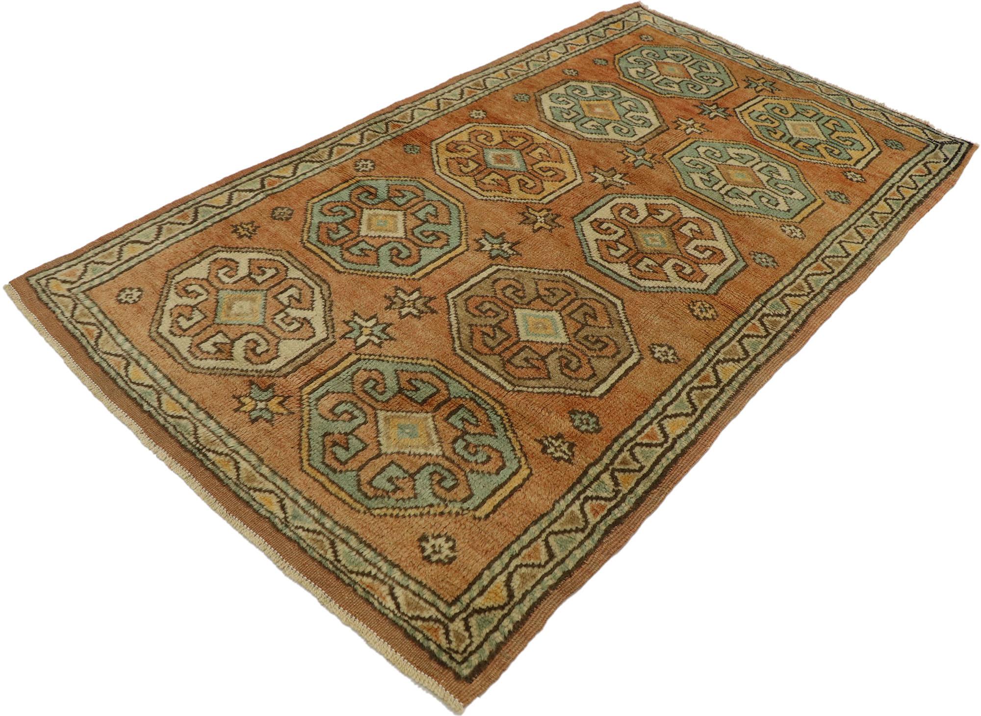 53179, vintage Turkish Oushak rug with Rustic Spanish Revival style. This hand-knotted wool vintage Turkish Oushak rug features two columns of octagonal medallions surrounded by eight-pointed stars and rosettes floating upon an abrashed orange