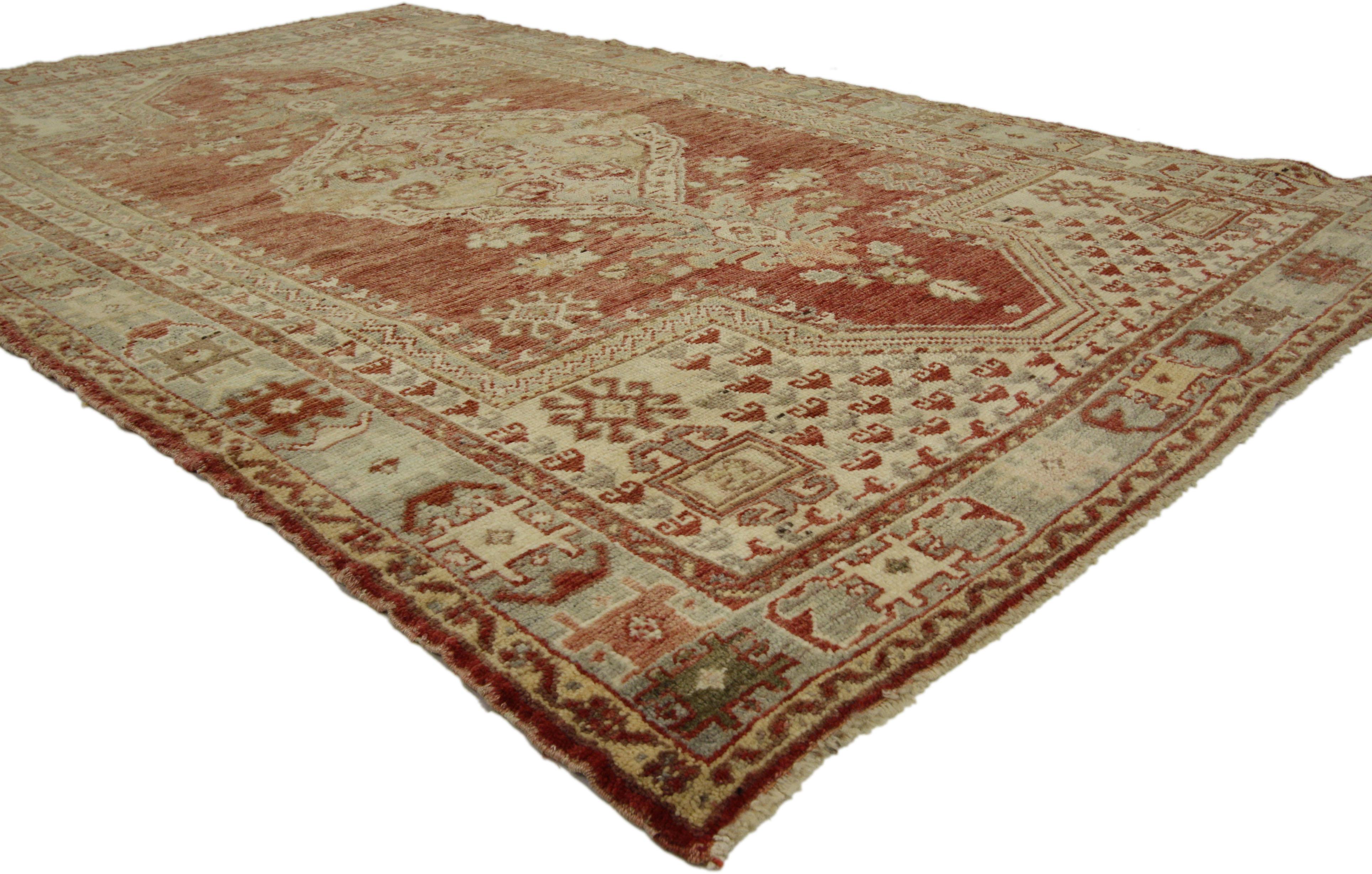 73890, vintage Turkish Oushak rug with rustic style, Anatolian Turkish Prayer rug. This hand knotted wool vintage Turkish Oushak rug features a large-scale boteh filled central medallion anchored with blooming palmettes at either end and dotted with