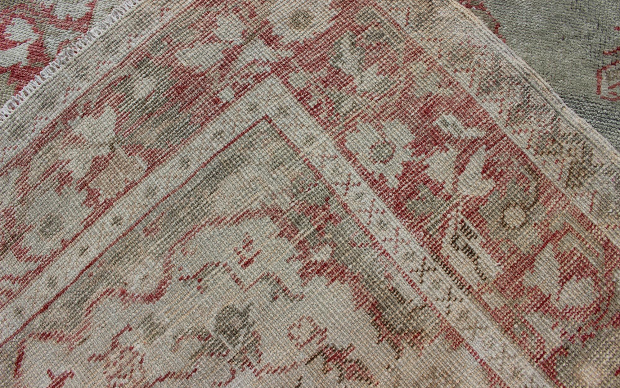 Measures: 3'6 x 6'3 
Vintage Turkish Oushak Rug with Soft Gray Field and Rose-Red Floral 3'6 x 6'3. Keivan Woven Arts / Rug / EN-176585, country of origin / type: Turkey / Oushak, circa 1940.

This vintage Turkish Oushak rug presents a graceful
