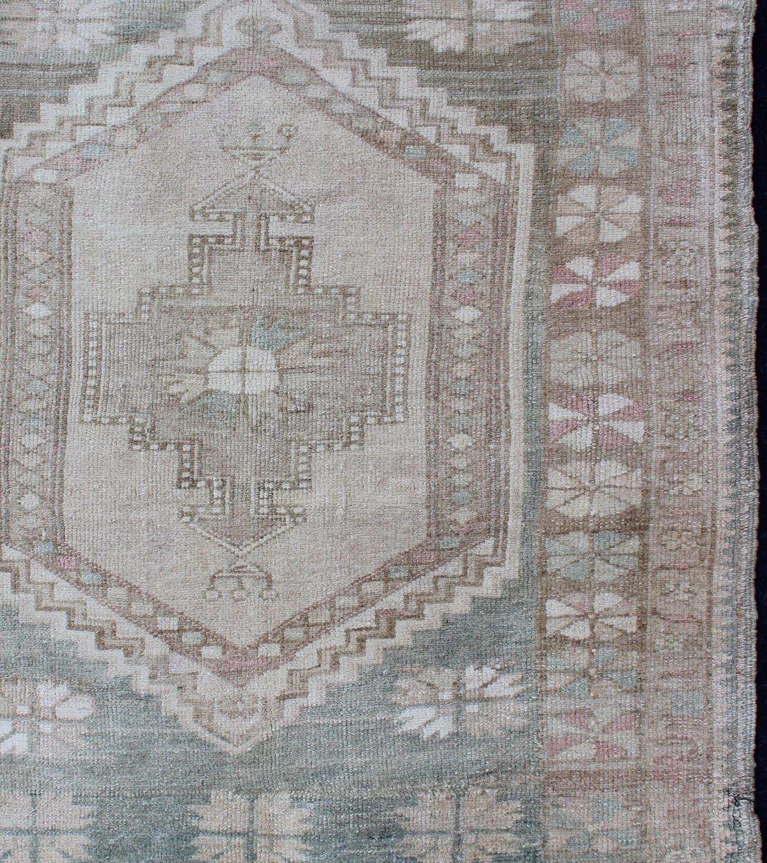 Square size vintage Turkish Oushak rug with stylized medallion in tan, cream and light green, rug EN-176982, country of origin / type: Turkey / Oushak, circa 1940

This Turkish vintage Oushak rug, circa 1940 features an intricately beautiful and