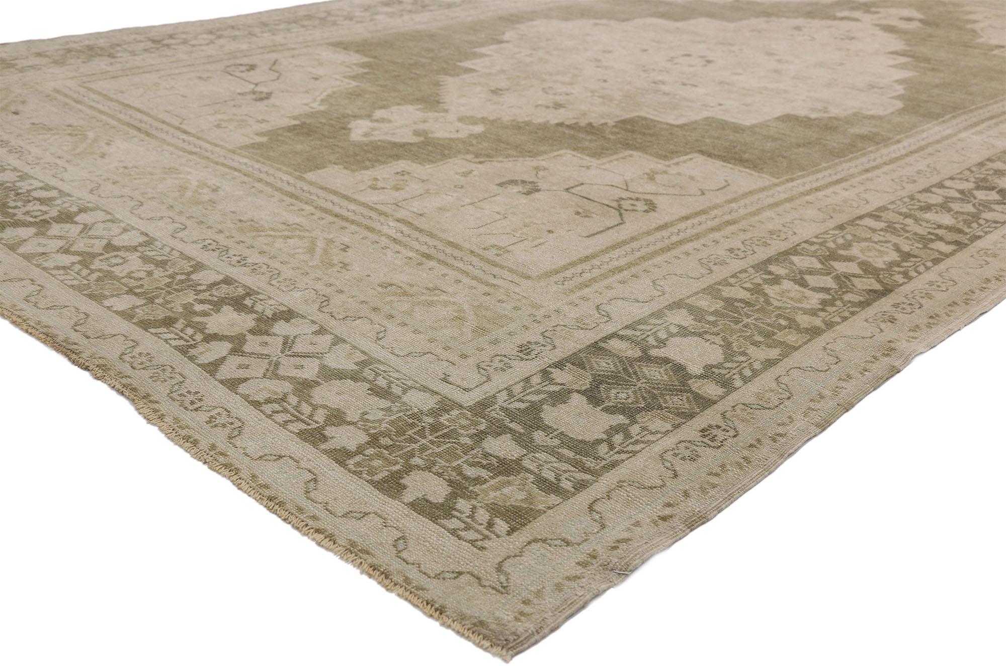 52488 vintage Turkish Oushak rug with Swedish Farmhouse and Cottage style. This daintily ornamented hand knotted wool vintage Turkish Oushak Rug features a large center medallion with anchor tip pendants floating in an open abrashed field. Angular