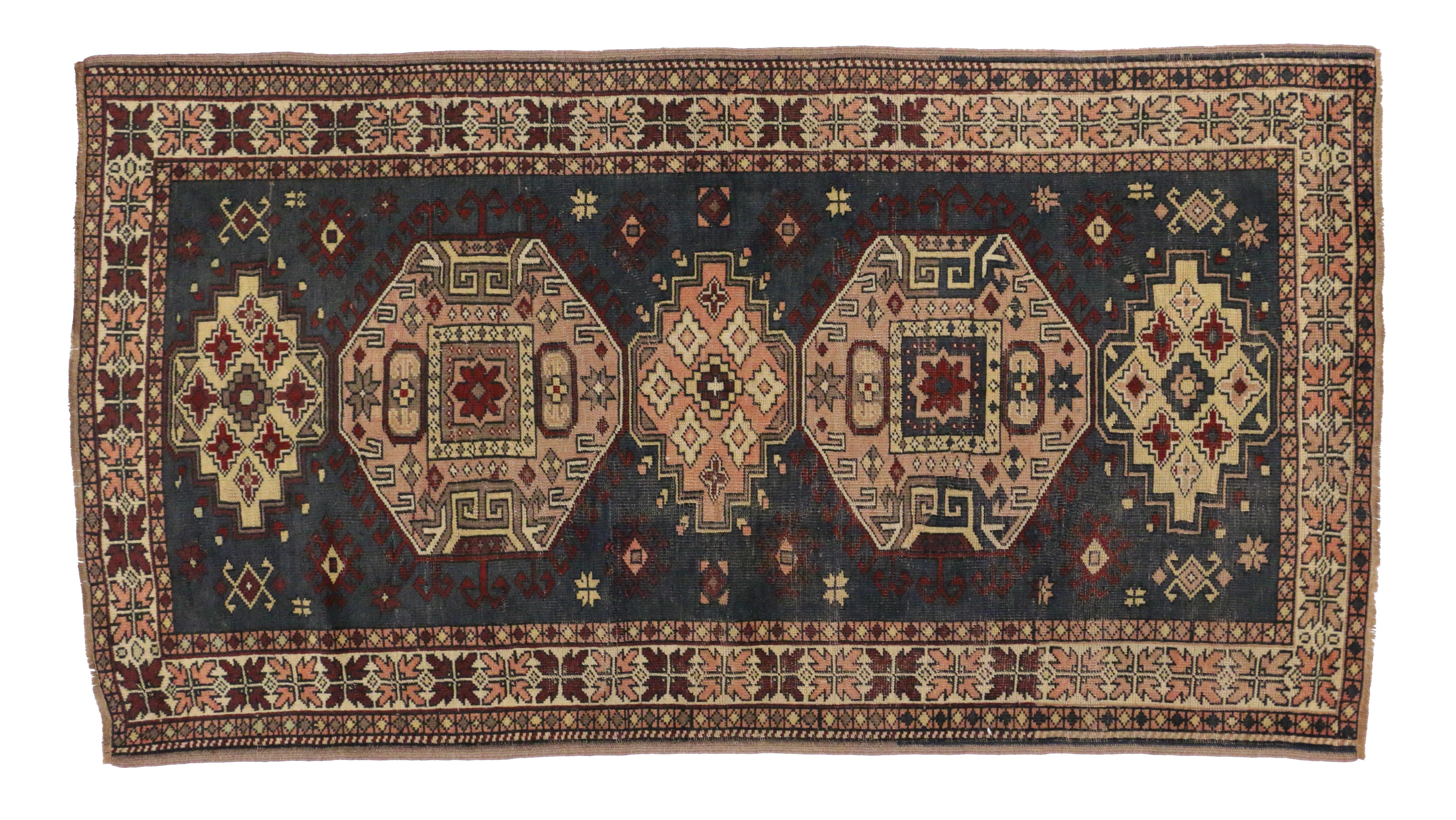 51406, vintage Turkish Oushak rug in a geometric floral medallion pattern. This opulent hand-knotted wool vintage Oushak rug features stacked geometric medallions dotted with stylized flowers and Turkish tribal motifs on a dark charcoal blue-gray