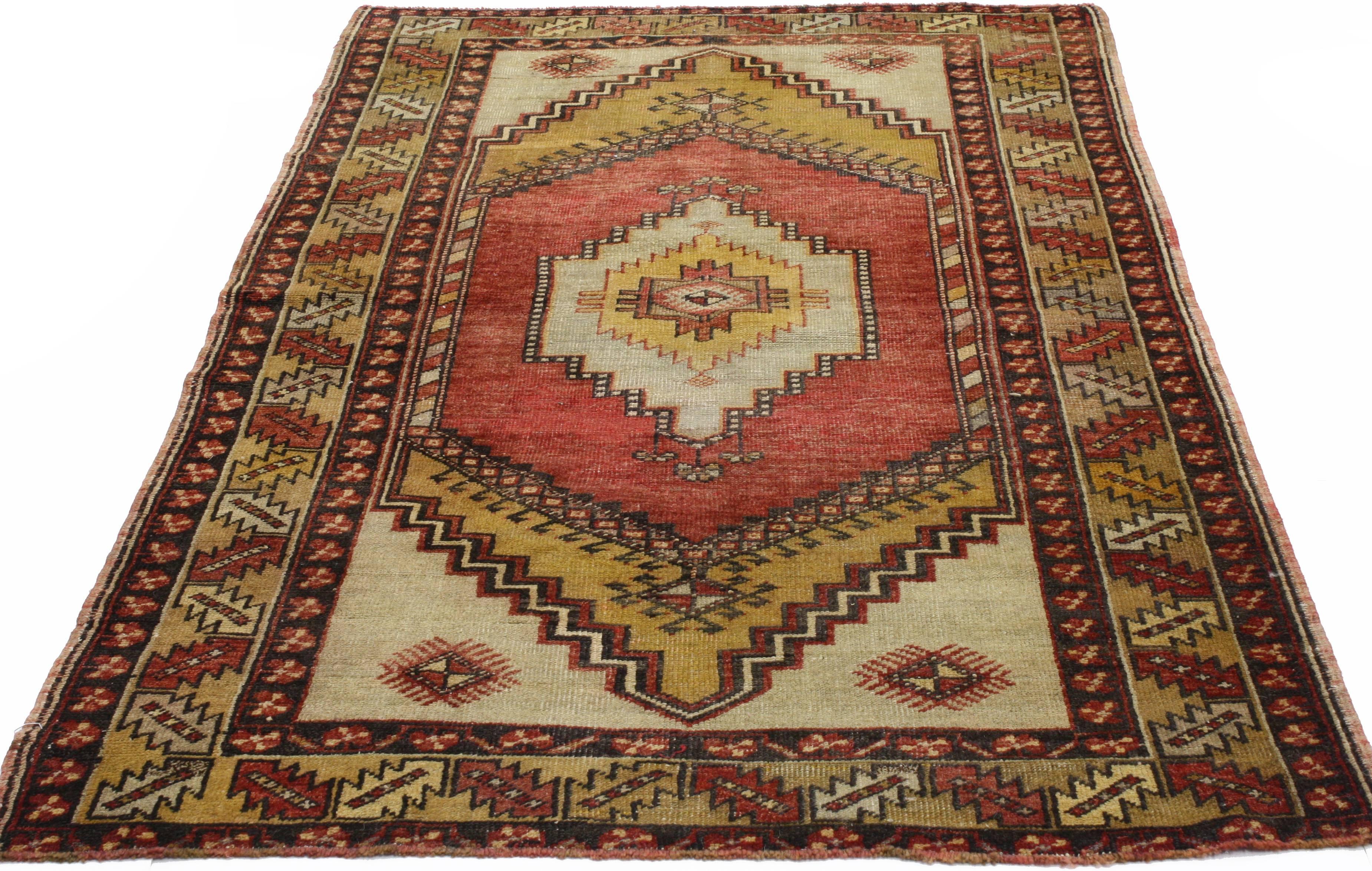 50325, vintage Turkish Oushak rug with traditional style and tribal elements. This hand-knotted wool vintage Oushak accent rug features an overlapping central lozenge with a stair-step border in variegated shades of saffron, red and light grey. The