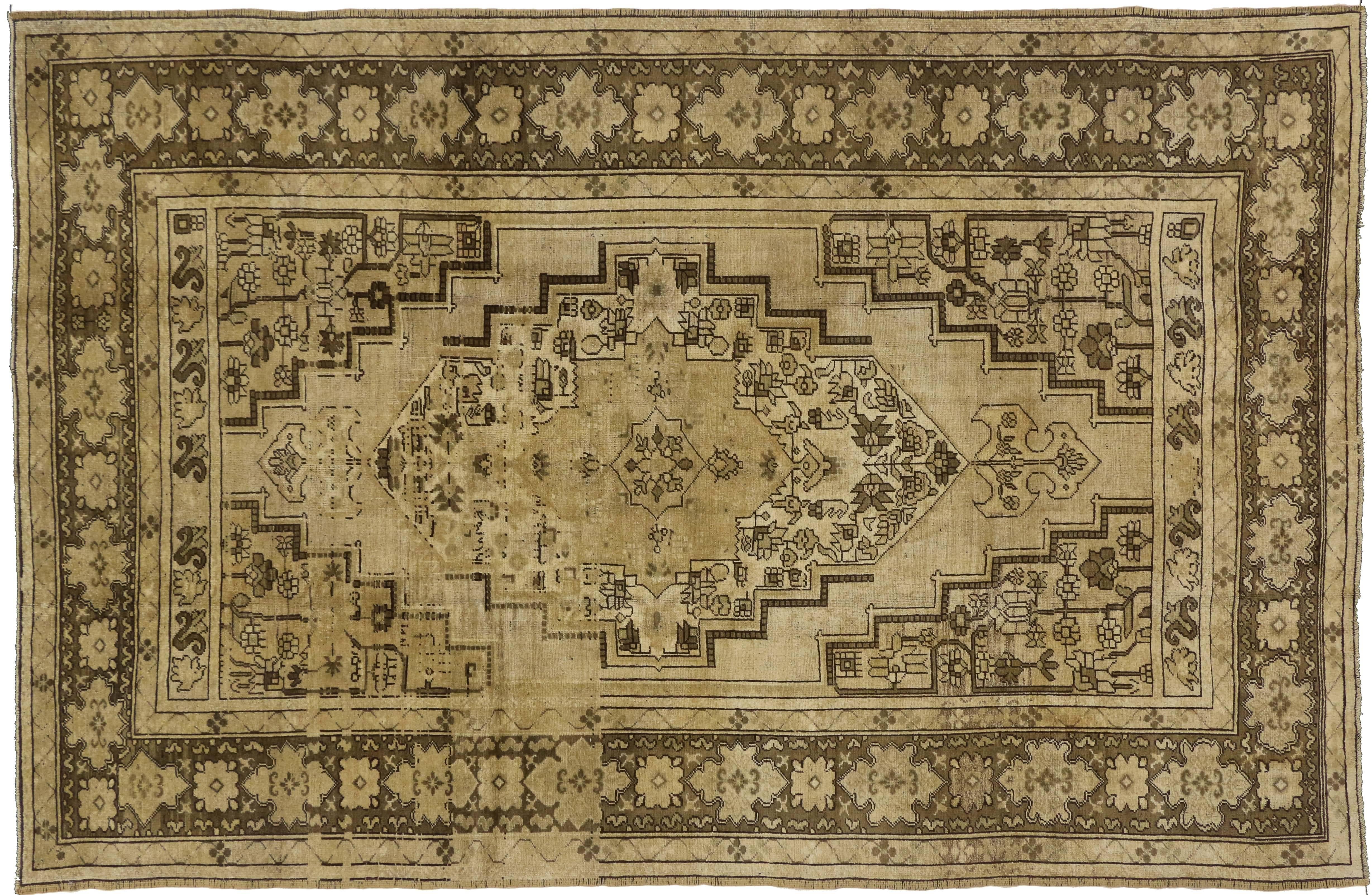 74073, vintage Turkish Oushak rug with traditional style and warm earth-tones. This hand-knotted wool vintage Turkish Oushak rug features a central angular stair-step medallion filled with stylized vines blooming with palmettes. The medallion floats