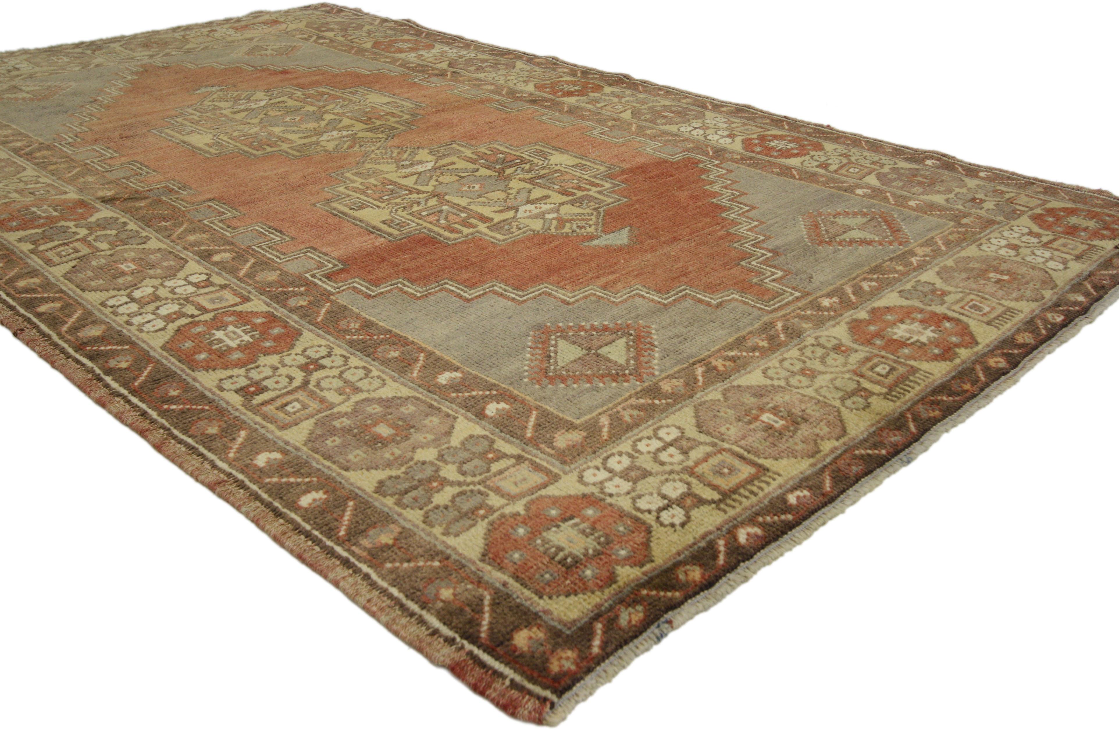 50078 Vintage Turkish Oushak Accent Rug, Entry or Foyer Rug. This hand-knotted wool vintage Turkish Oushak wool rug features a double medallion with tribal motifs in an open abrashed field surrounded by a geometric border. color palette consists of