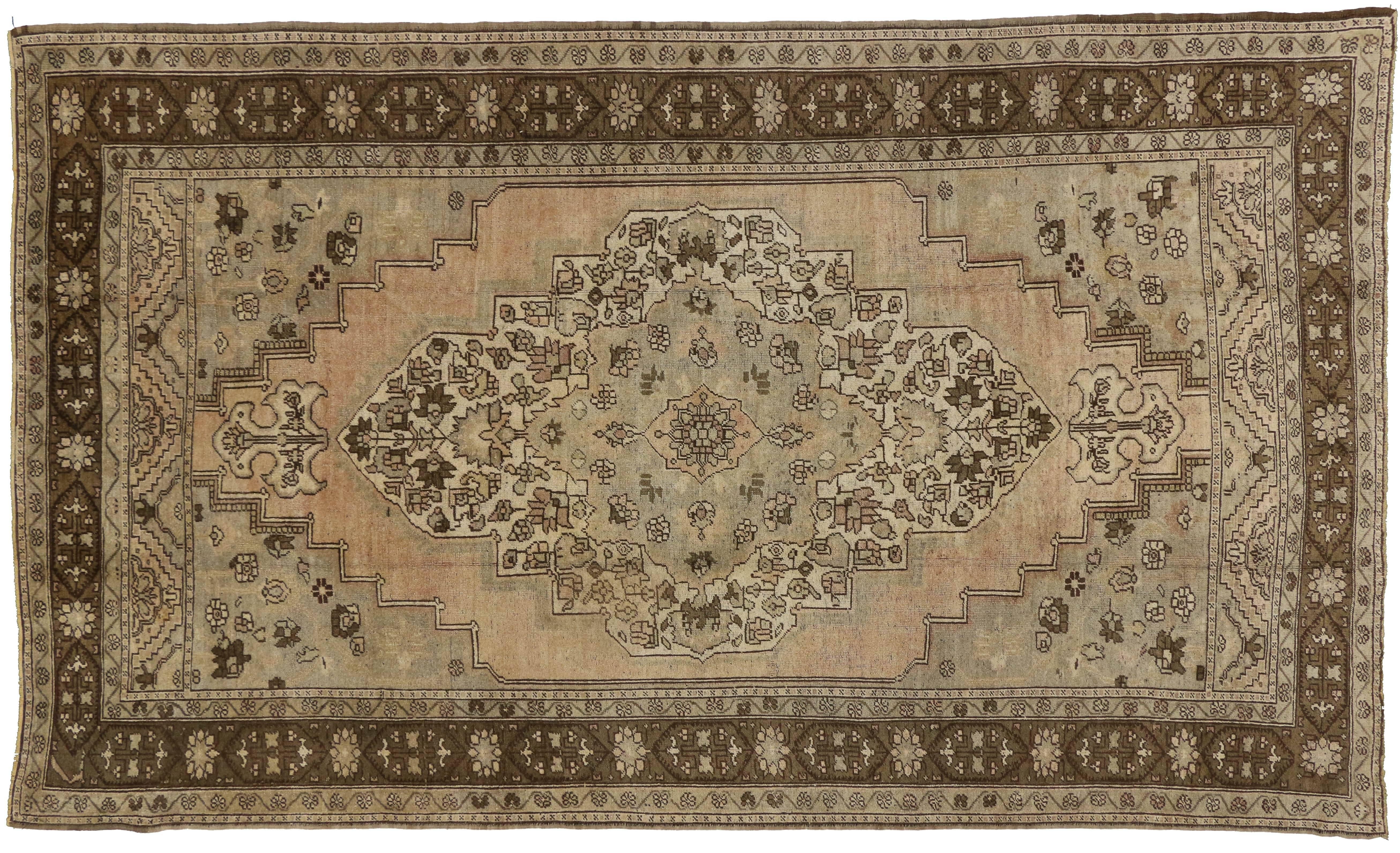 73945, Vintage Turkish Oushak Rug with Warm, Neutral Colors, 06'10 X 11'07. A large anchor medallion patterned with geometric stylized flowers floats on an abrashed field. Spandrels are dotted with stylized flowers and tiny buds. The vintage Turkish