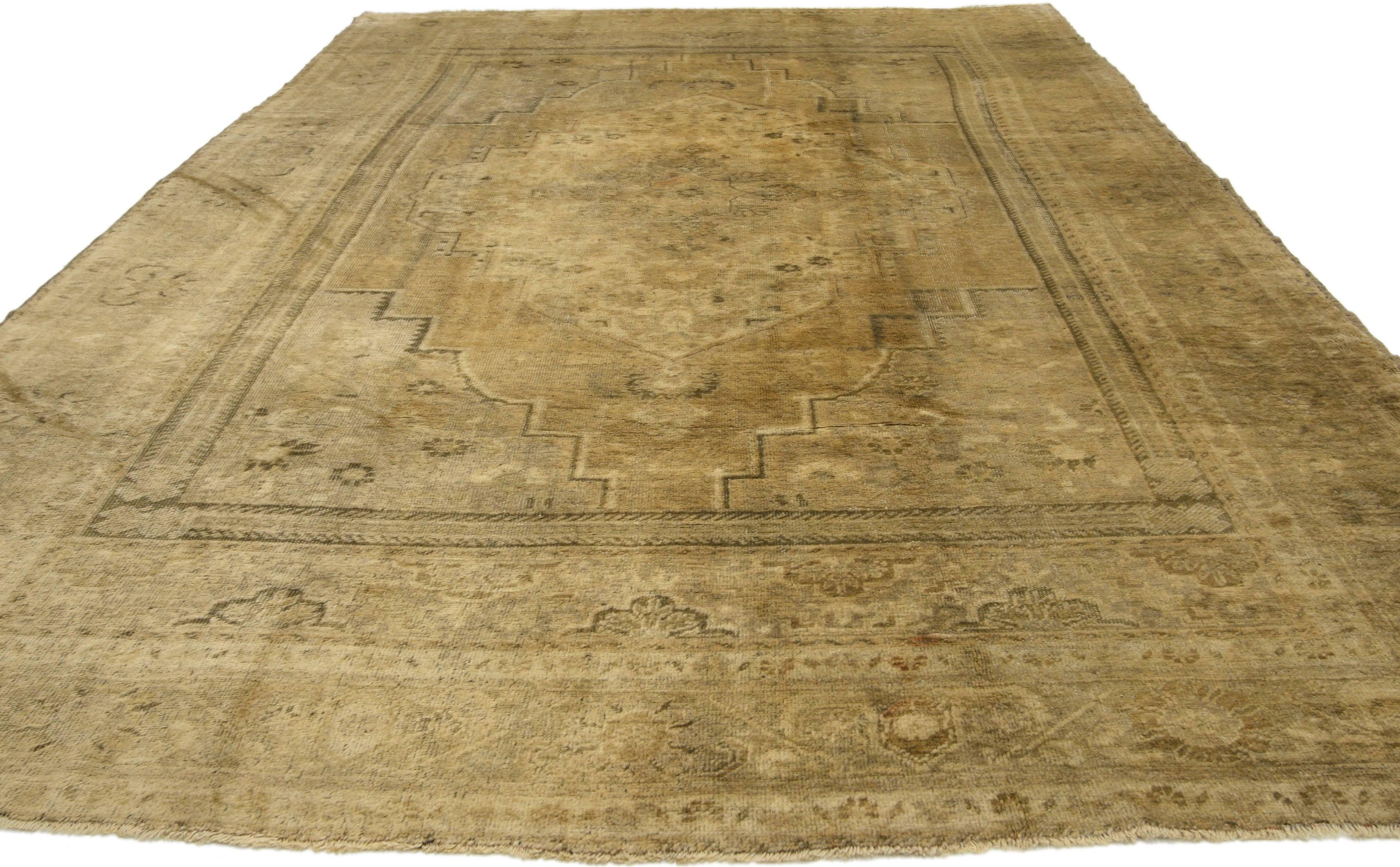74093, vintage Turkish Oushak rug with traditional style. This hand-knotted wool vintage Turkish Oushak rug features a cusped central medallion in an abrashed field. It is framed with mihrab style quarter panels and enclosed with a complementary