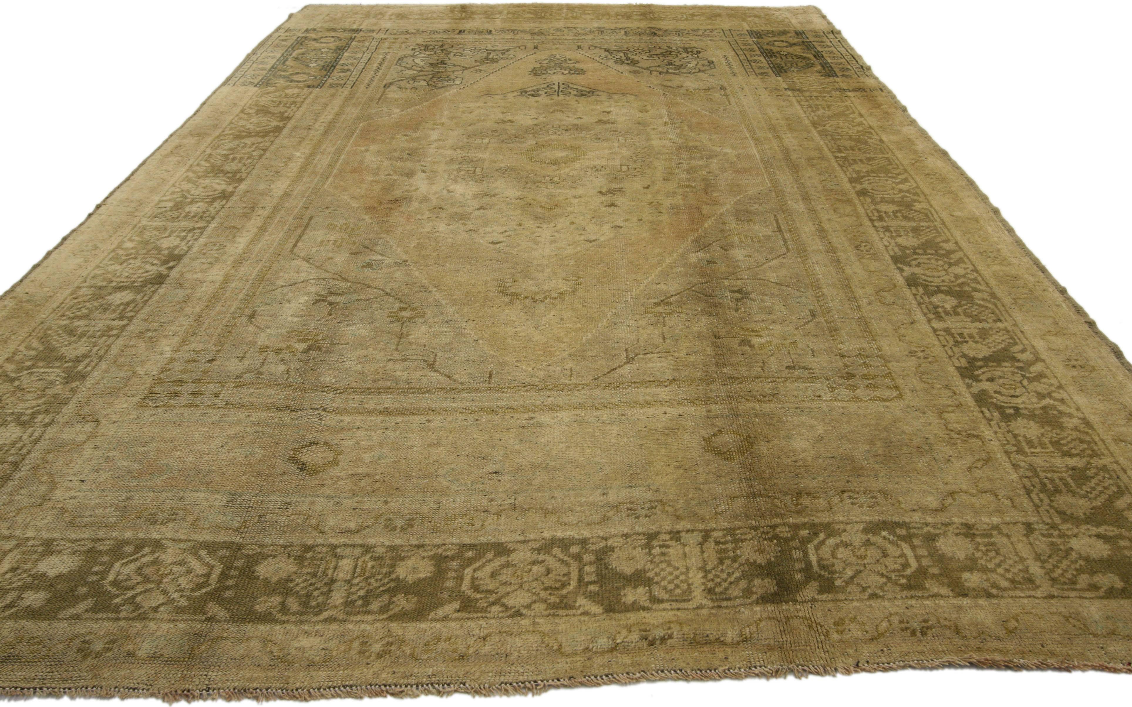 74094, vintage Turkish Oushak rug with traditional style. This hand-knotted wool vintage Turkish Oushak rug features a cusped central medallion in an abrashed field. It is framed with mihrab style quarter panels and enclosed with a complementary