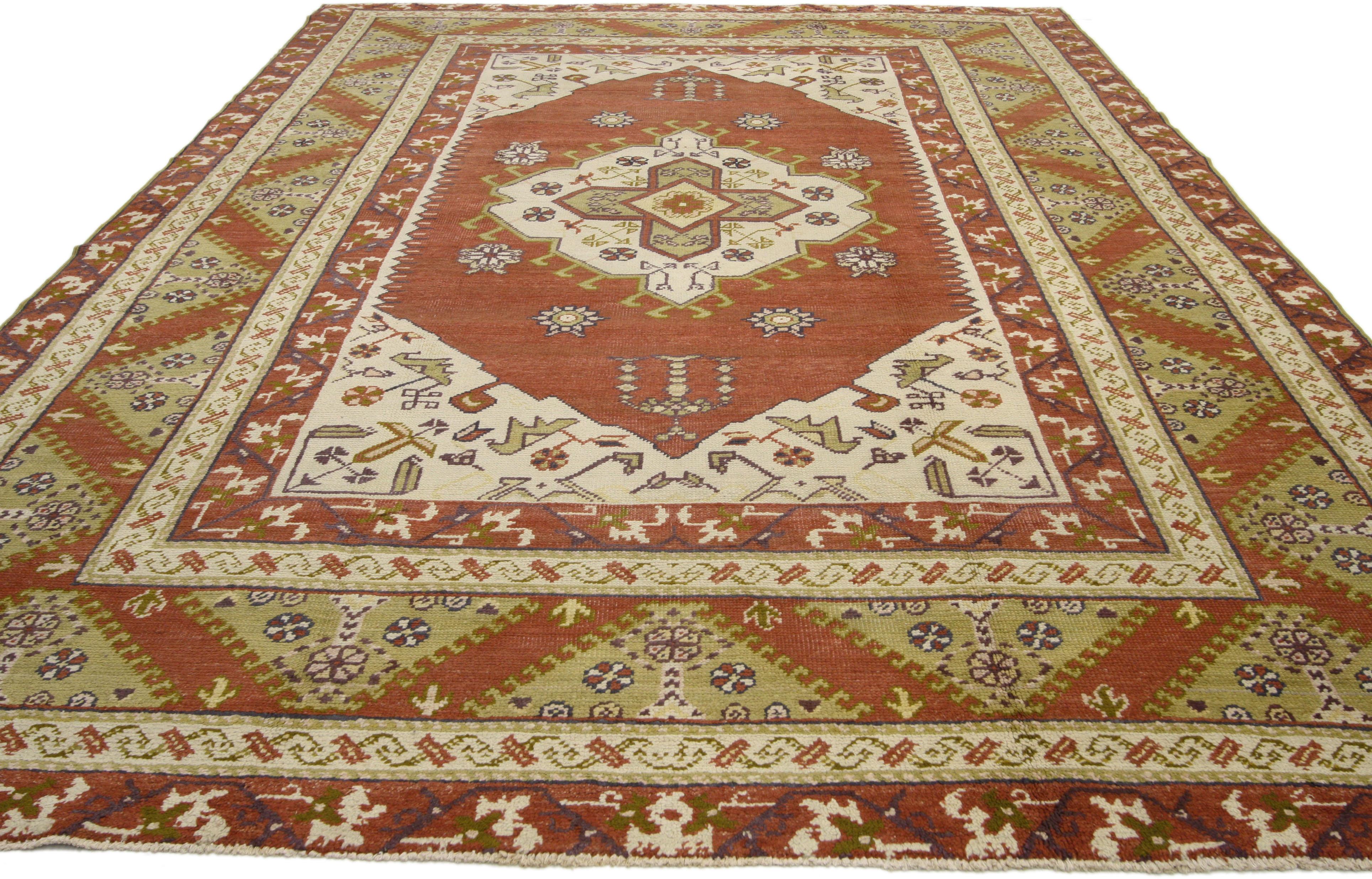 72489 vintage Turkish Oushak rug with Tribal Artisan style. This hand knotted wool vintage Turkish Oushak rug embodies an Artisan style. Immersed in Anatolian history and warm colors, this vintage Oushak rug features a center medallion filled with a