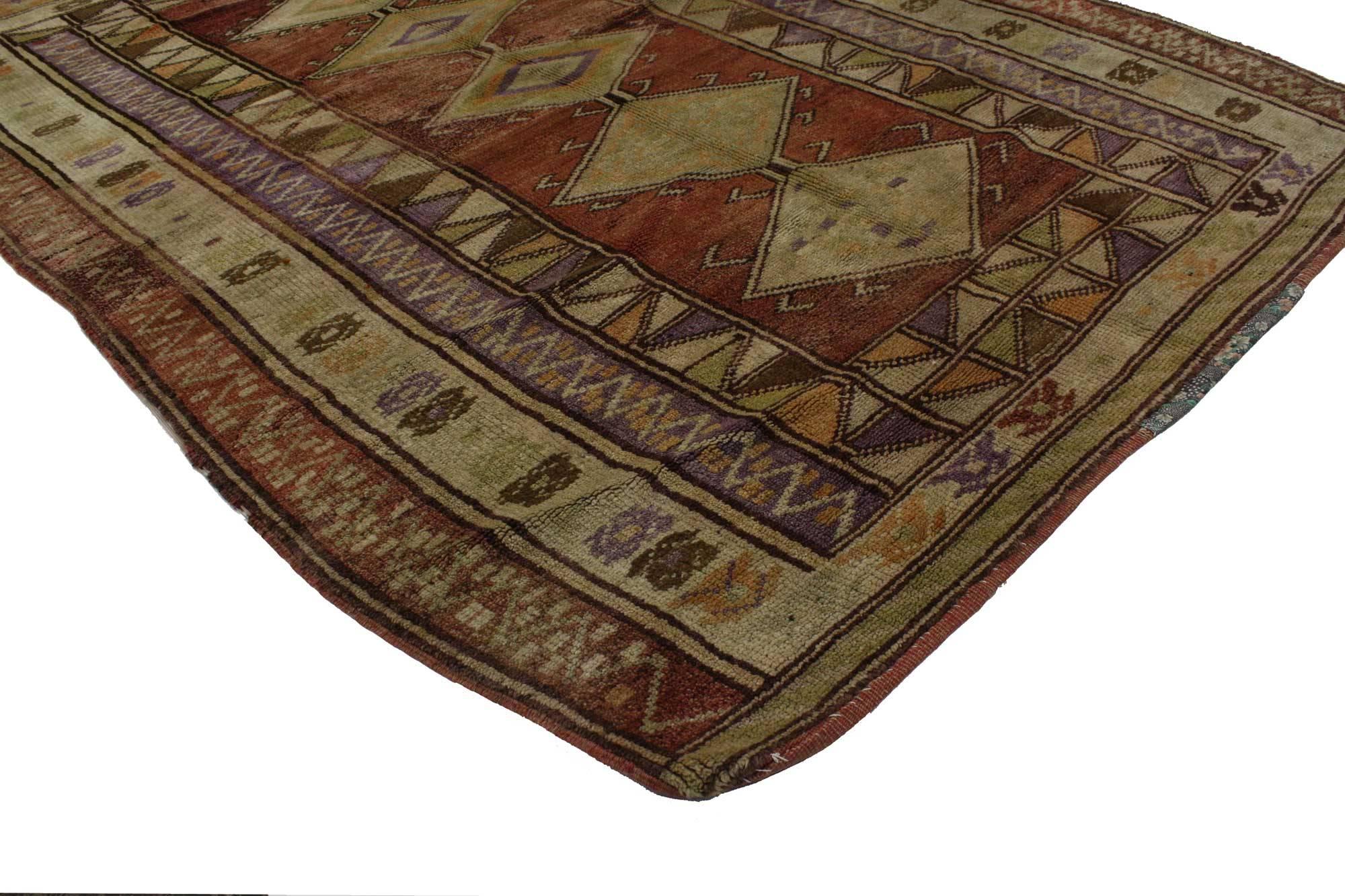 51681, vintage Turkish Oushak rug with tribal Mid-Century Modern style. This hand knotted wool vintage Turkish Oushak rug features five stacked hooked diamond-shaped pole medallions spread across an abrashed maroon field. A wonderful series of