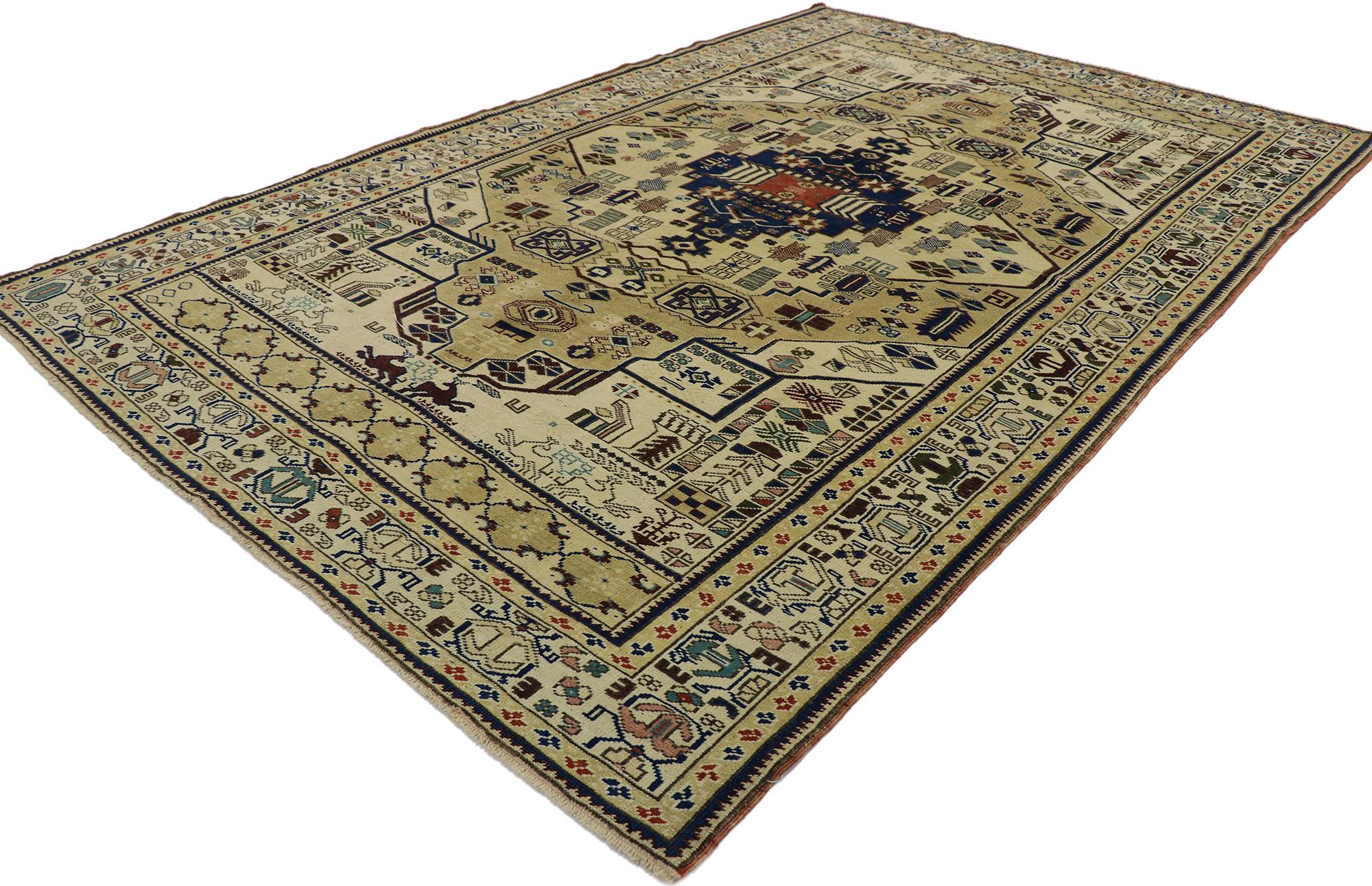 53225, vintage Turkish Oushak rug with Tribal style. Displaying a charming masculine appeal and the embodiment of tribal style, this hand knotted wool vintage Turkish Oushak rug is a captivating vision of woven beauty. The abrashed cut-out field
