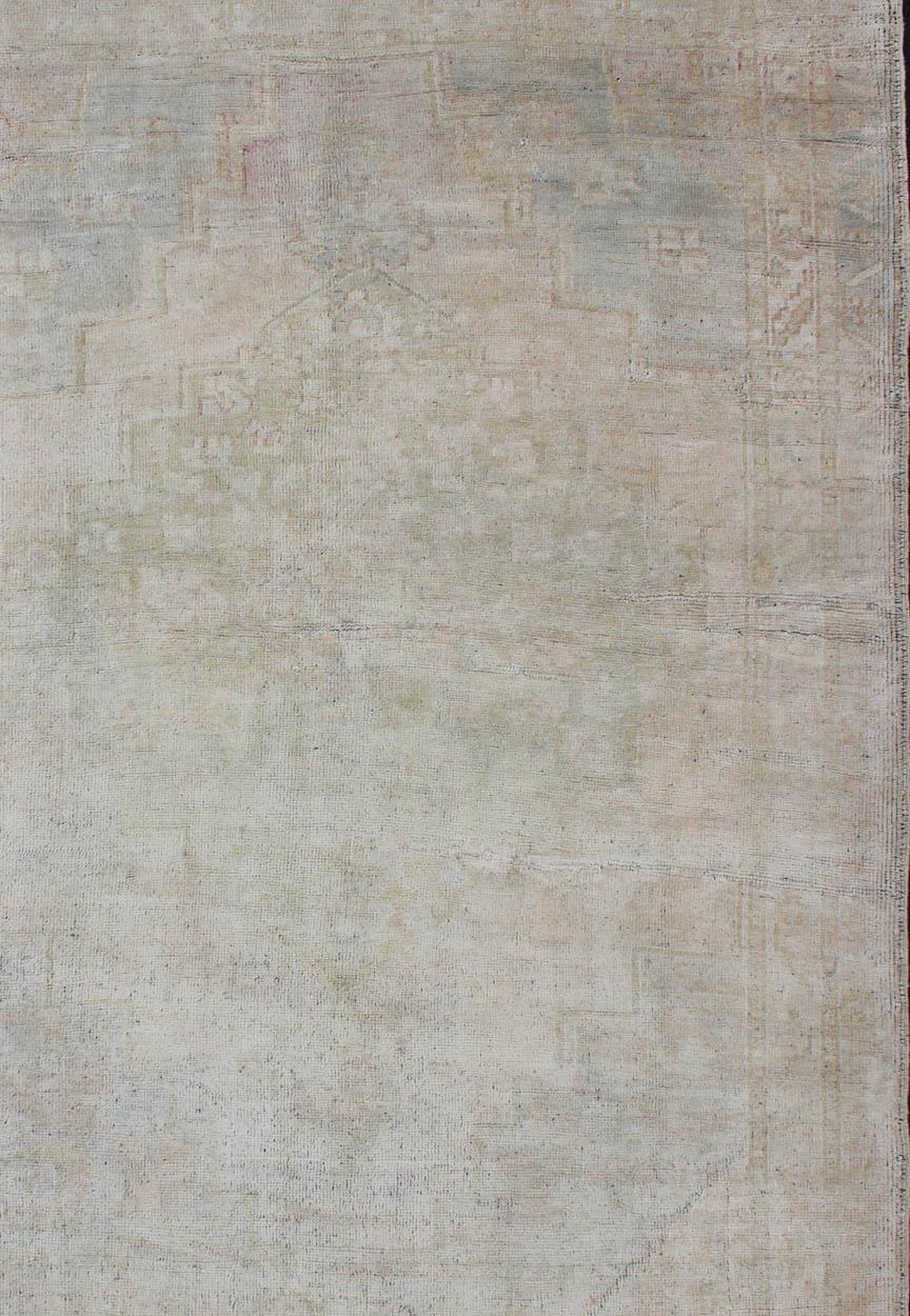 Wool Vintage Turkish Oushak Rug with Understated Design and Muted Tones For Sale