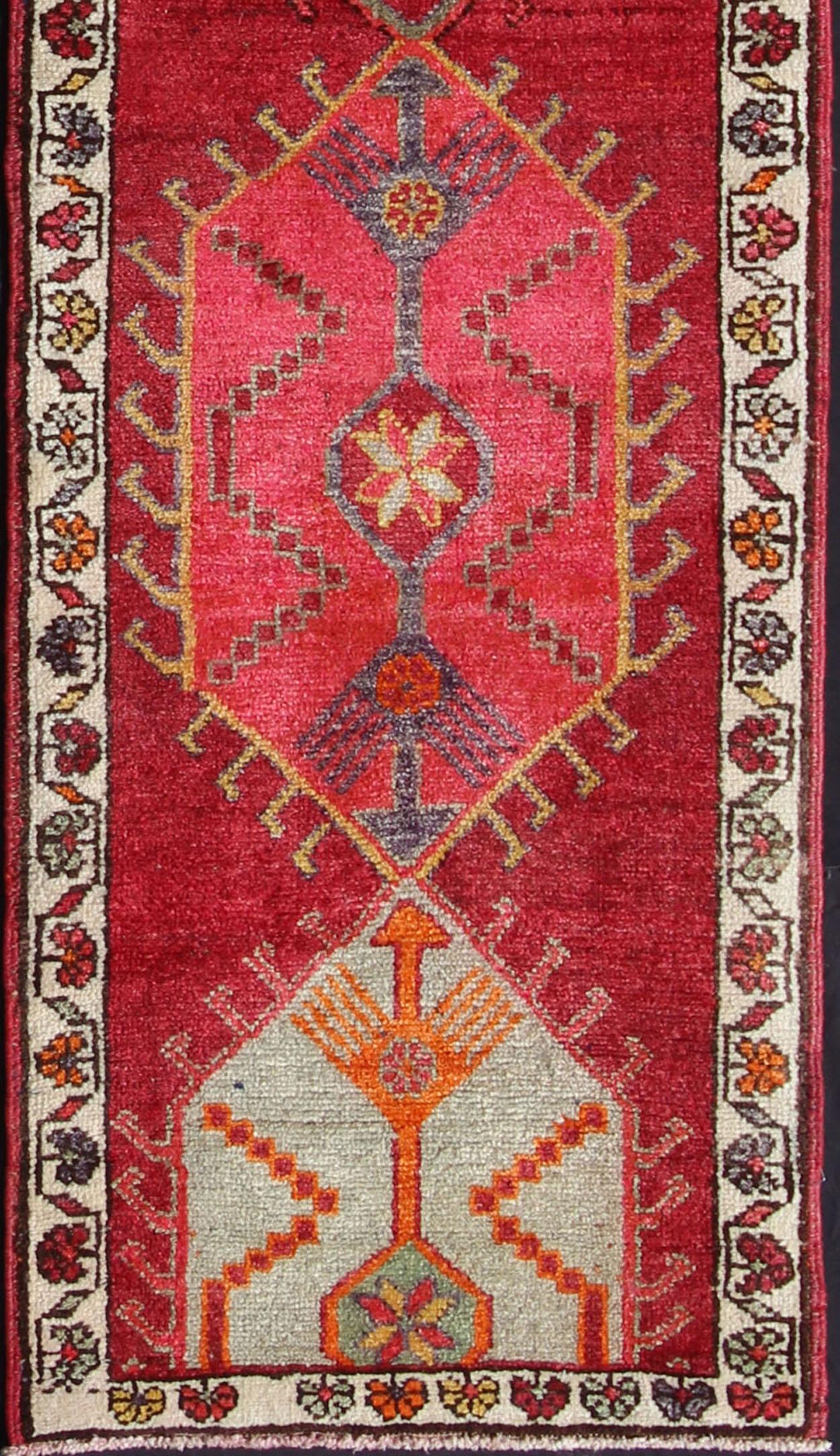 Measures: 2'10'' x 12'10''.
This Oushak carpet from mid-20th century Turkey features a stunning multi-medallion design rendered in geometric patterns enclosed within a repeating background. This piece is rendered in a large variety of color tones,