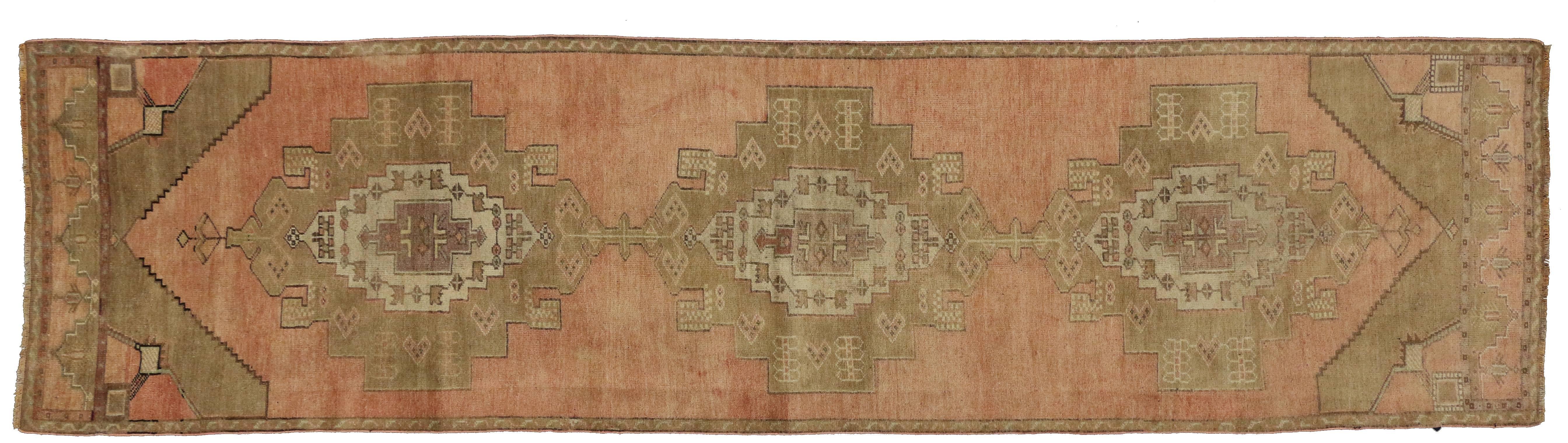 50284, vintage Turkish Oushak runner, hallway runner with Tribal Style, soft colors. This hand-knotted wool vintage Turkish Oushak carpet runner features three medallions with stair-step edges and each filled with a concentric medallion on an