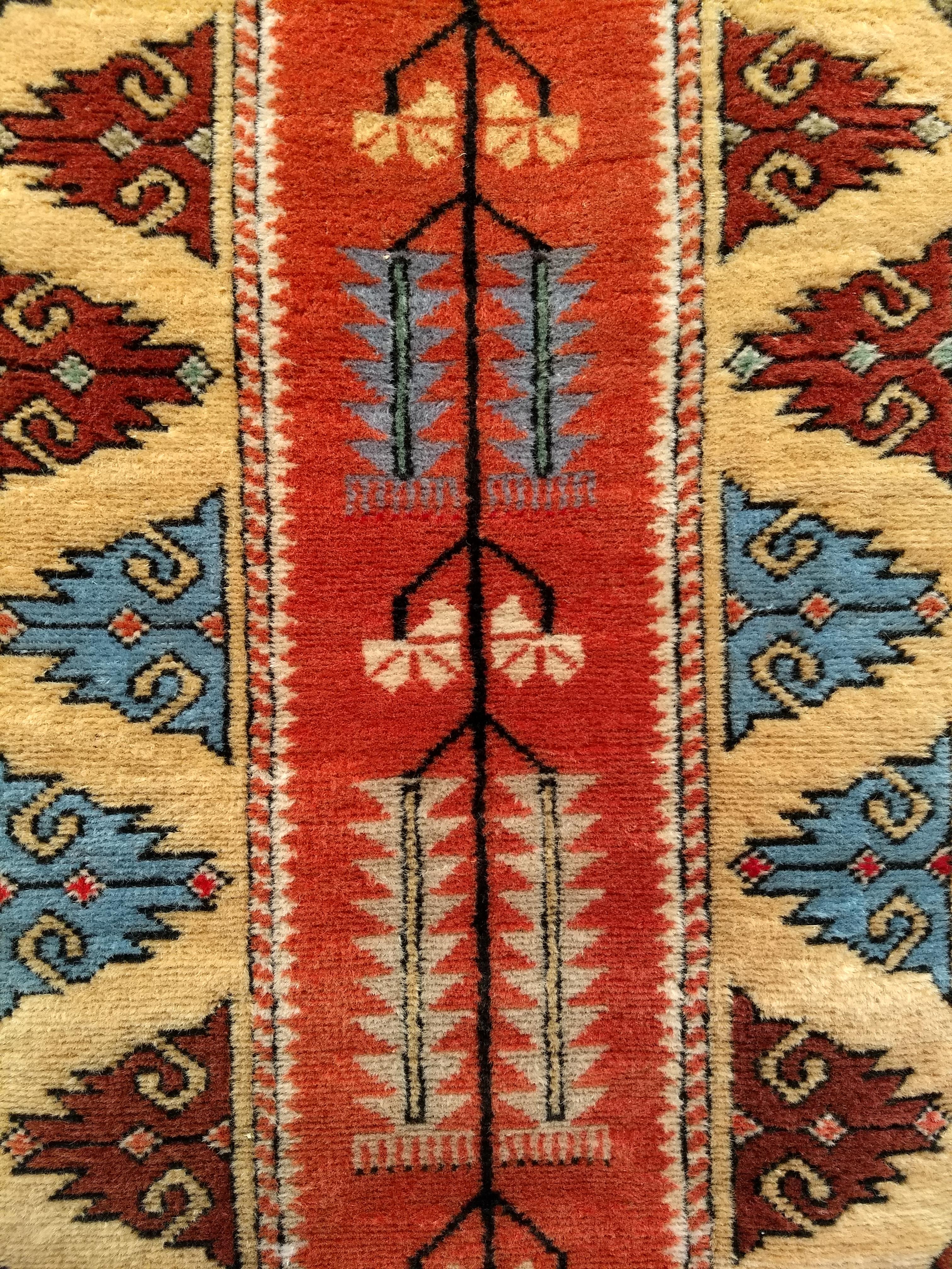 A vintage Turkish Oushak colorful runner in a geometric design from the mid-1900s. The rug has a modern design and beautiful bright colors including green, blue, brown, yellow, pink, and red colors in the field and the border. The center of the