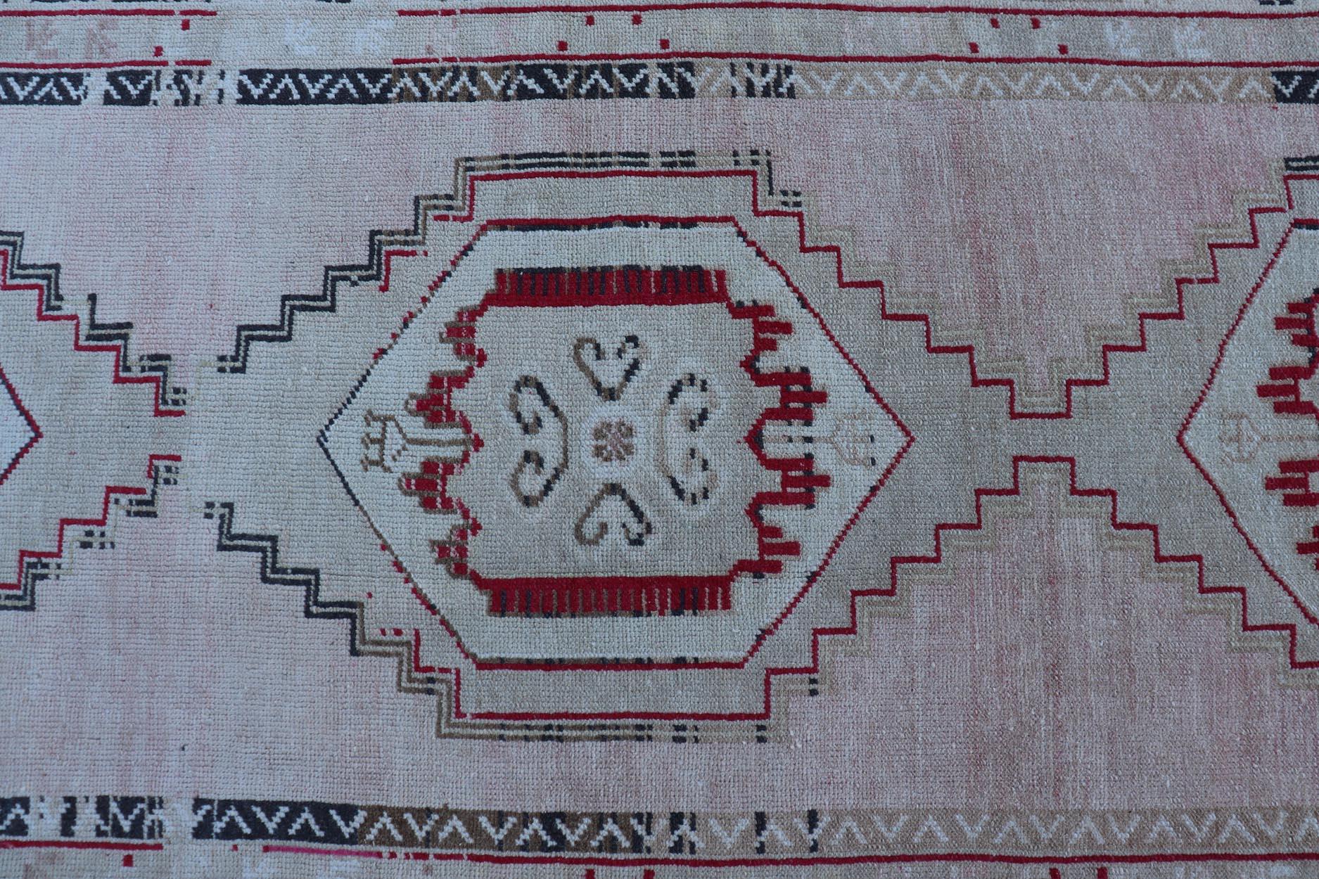 Vintage Turkish Oushak Runner with Medallions in Cream, dark blue, pink and Red. Rug EN-178468, country of origin / type: Turkey / Oushak, circa 1940.

Measures: 3'7 x 10'6
 
This unique vintage Turkish Oushak runner features stylized medallions