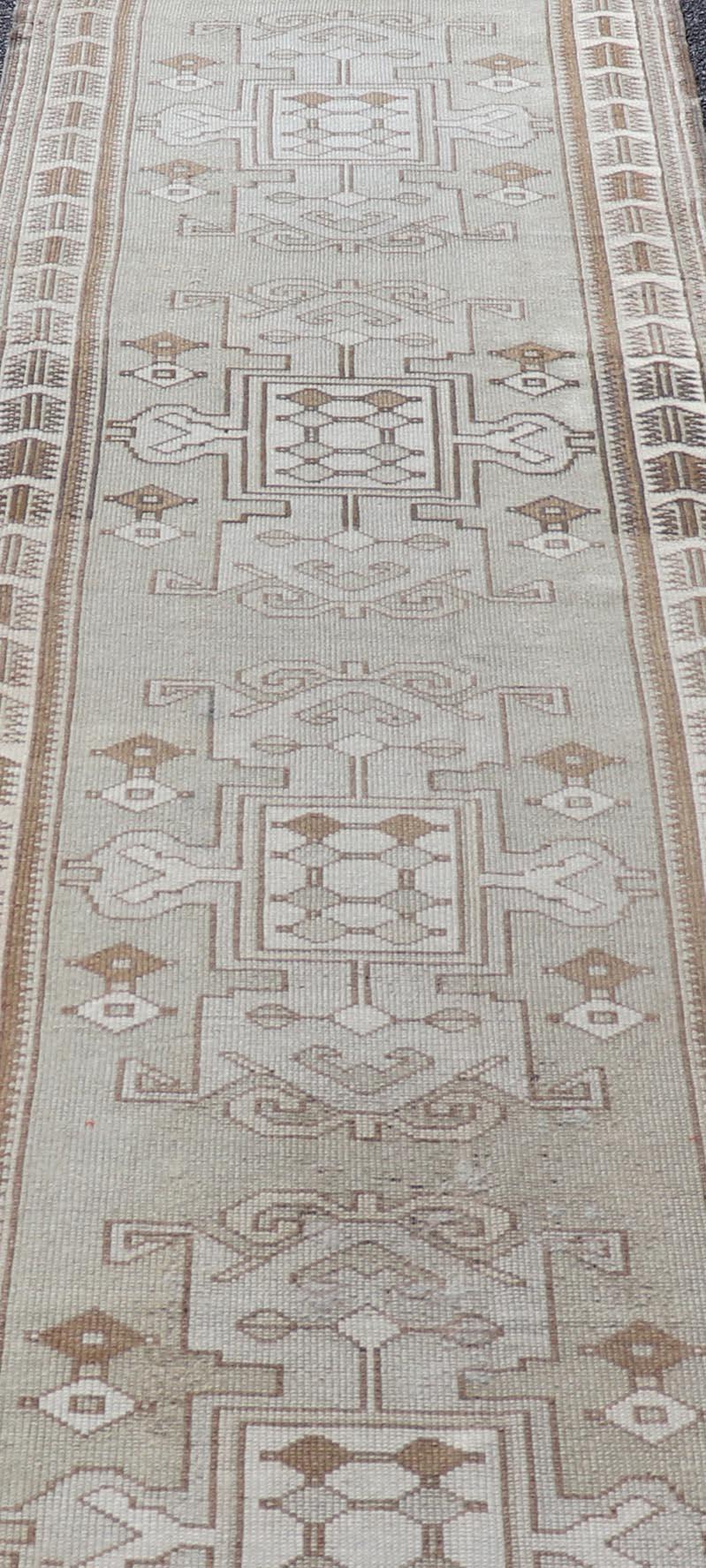 Measures: 2'10 x 10'0 
Vintage Turkish Oushak Runner in Neutral Tones, Taupe, Gray, Cream, and Brown. Keivan Woven Arts / rug EN-179108, country of origin / type: Turkey / Oushak, circa mid-20th.
This vintage Oushak carpet from mid-20th century