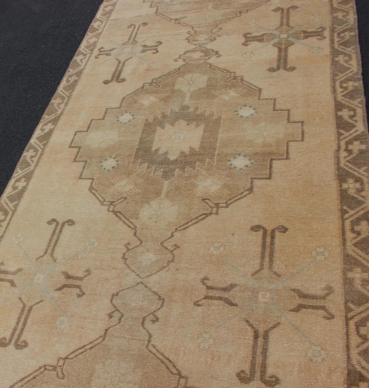 20th Century Vintage Turkish Oushak Runner Neutral and warm Colors with Tribal Medallions For Sale
