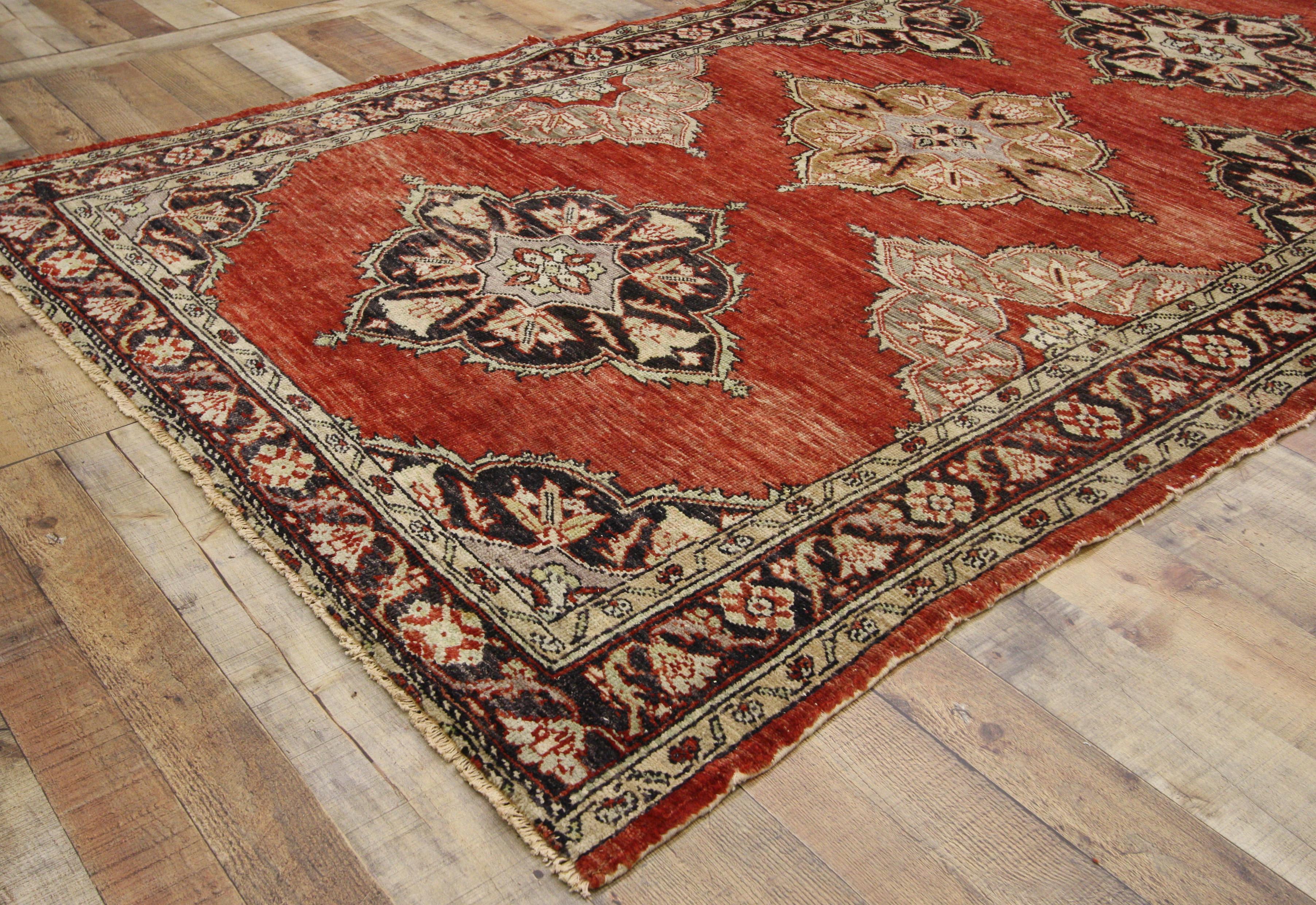 52388, vintage Turkish Oushak runner, wide hallway runner. This hand knotted wool vintage Turkish Oushak runner features five floral lobed diamond-shaped medallions spread across an abrashed red field. The petal-shaped lobes of the medallions