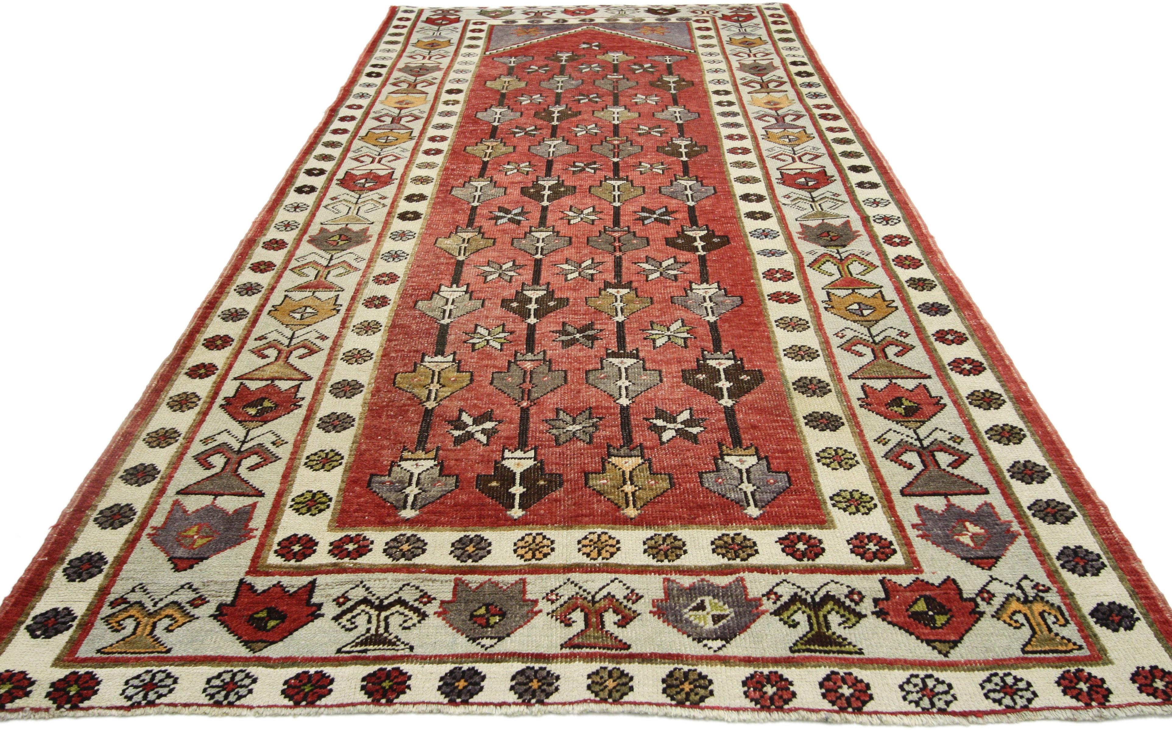52420 vintage Turkish Oushak runner, wide hallway runner. With its bright red field and faded eggplant spandrels, this hand knotted wool vintage Turkish Oushak runner is a woven beauty of contrasting vibrant and earth tones. Ancient symbolism