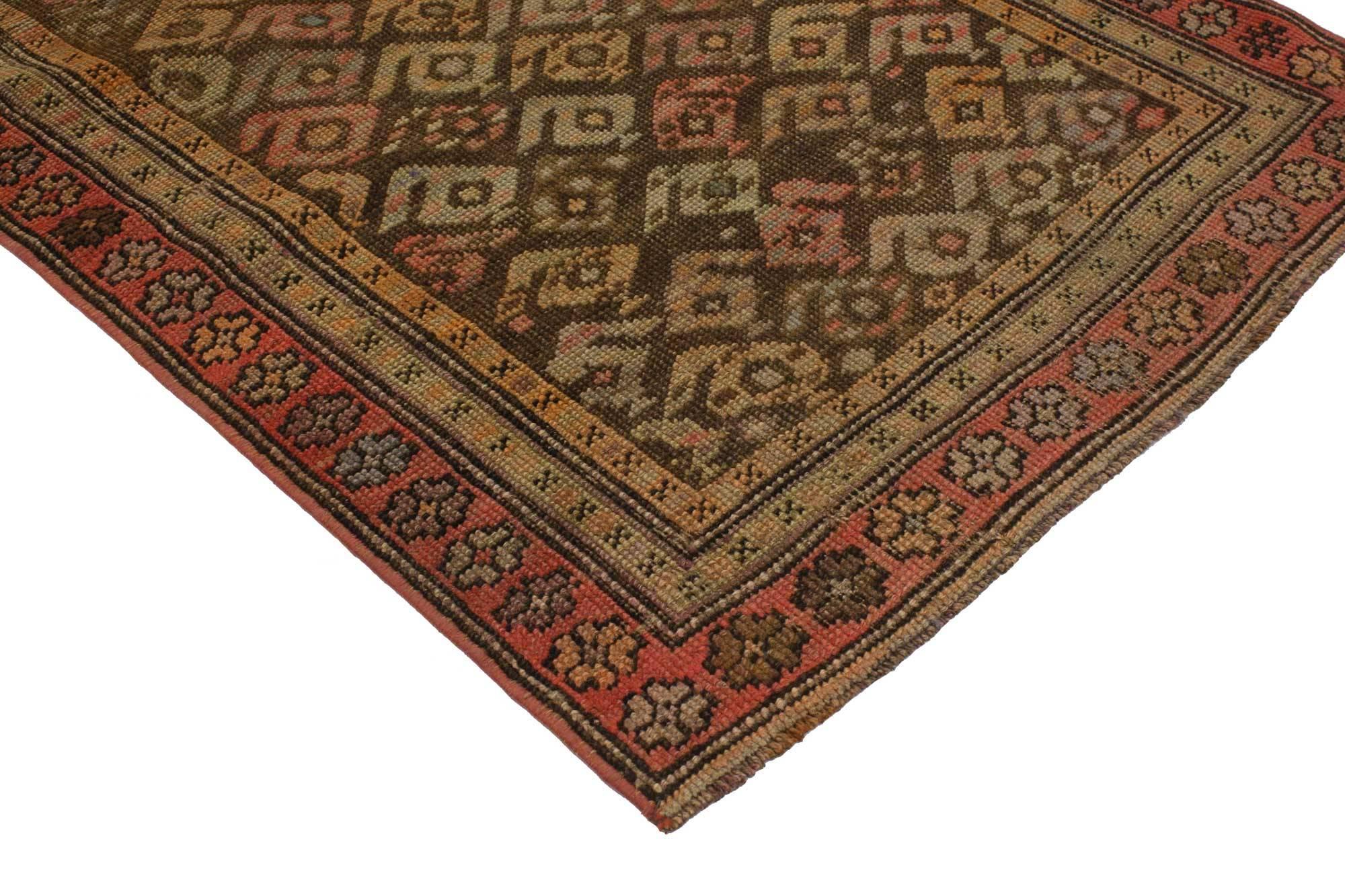 51721, vintage Turkish Oushak runner with craftsman style, short hallway runner. This hand knotted wool vintage Turkish Oushak runner features an all-over geometric boteh pattern spread across an abrashed coffee colored field. The widely used boteh