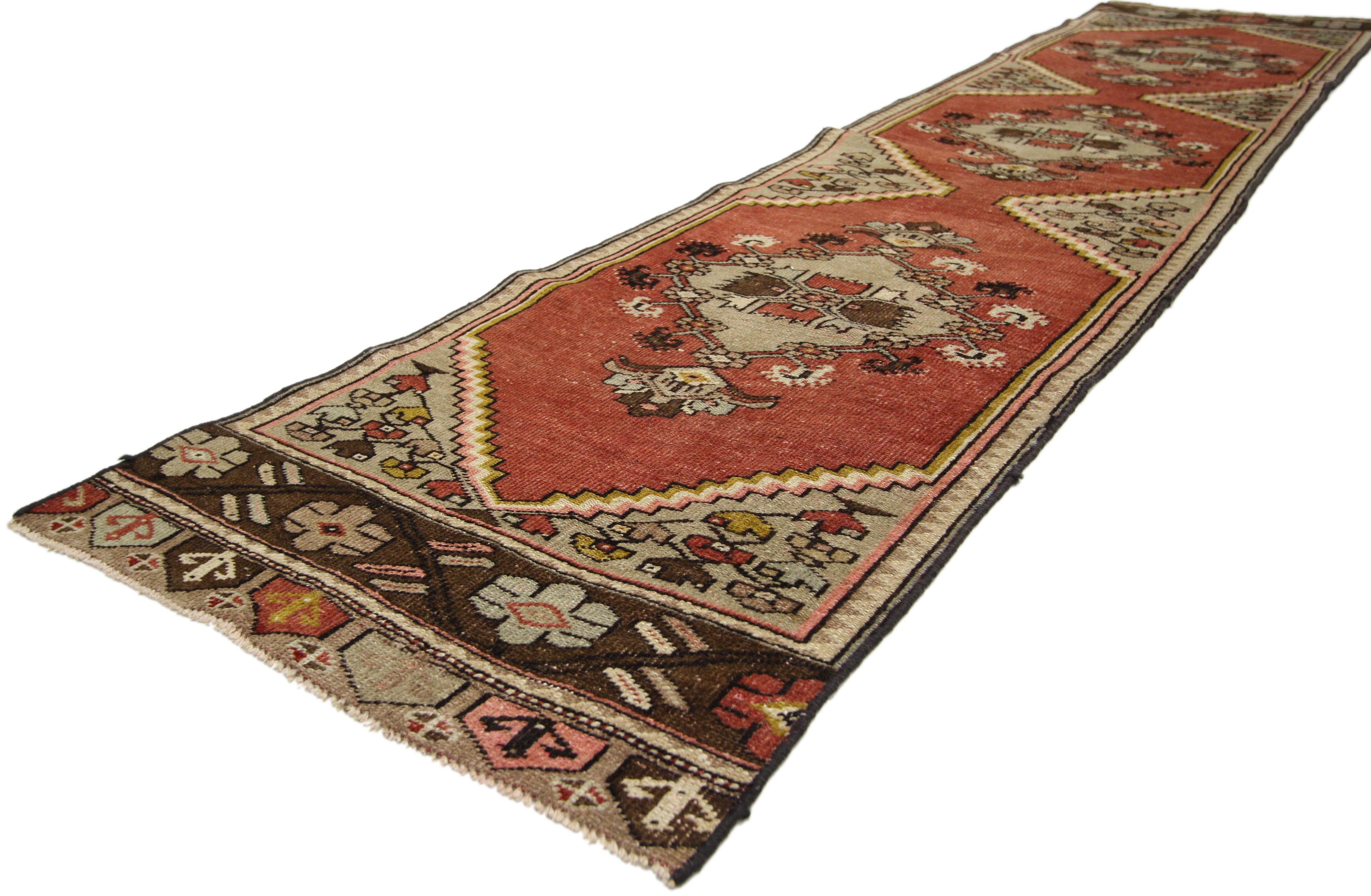 51147, vintage Turkish Oushak runner with English Country style, hallway runner. This hand knotted wool vintage Turkish Oushak runner features three floral lozenge-shaped medallions with palmette pendants spread across an abrashed brick red field.
