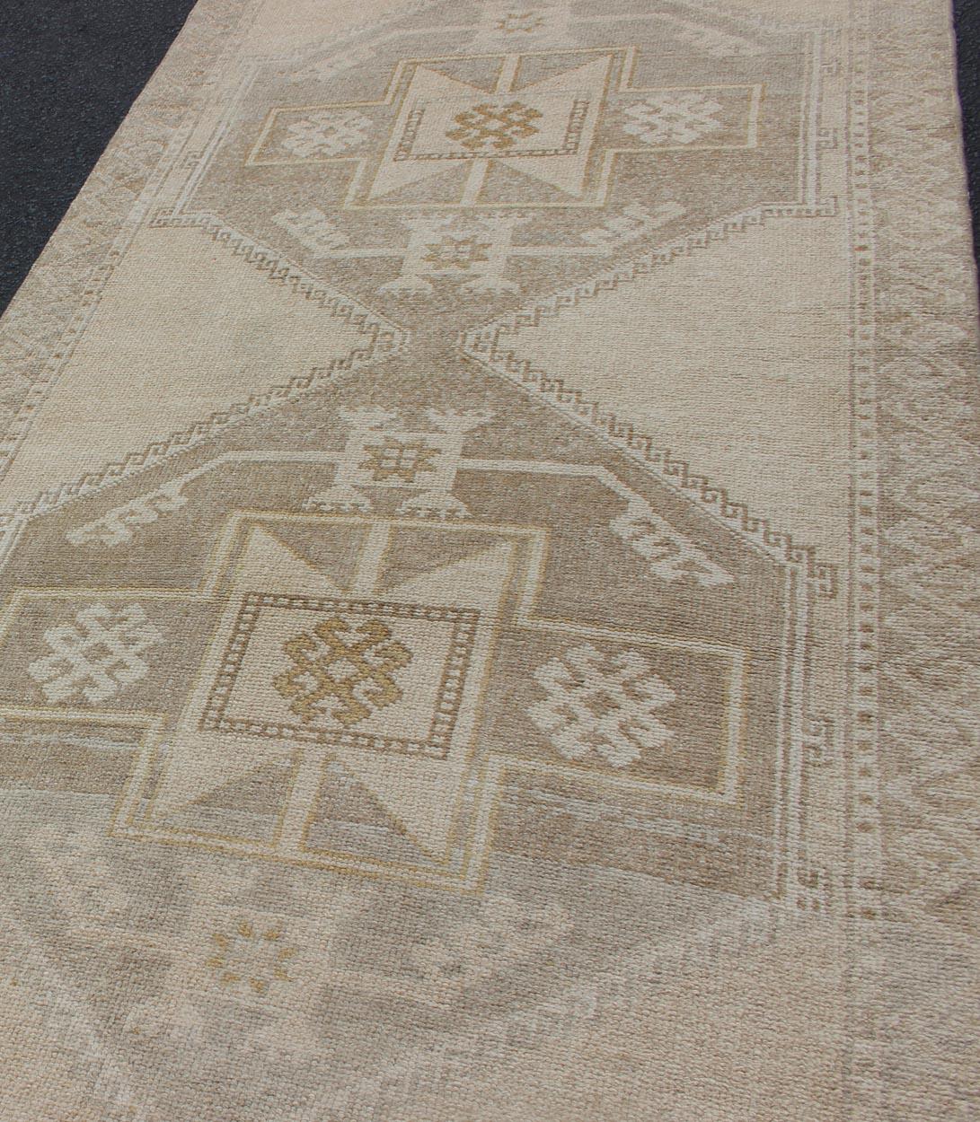 20th Century Vintage Turkish Oushak Runner with Etched Medallion Design in Soft Muted Tones For Sale