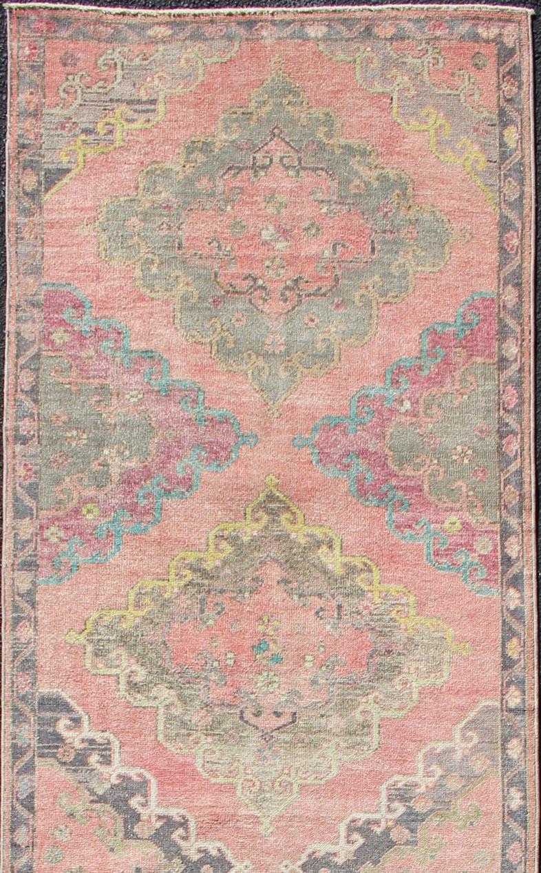 Colorful Vintage Hand Knotted Turkish Oushak Runner in muted tones

Measures: 3'4 x 12'3.

This vintage Turkish Oushak runner features four layered medallions expanding across the central field. The surrounding border features a complementary