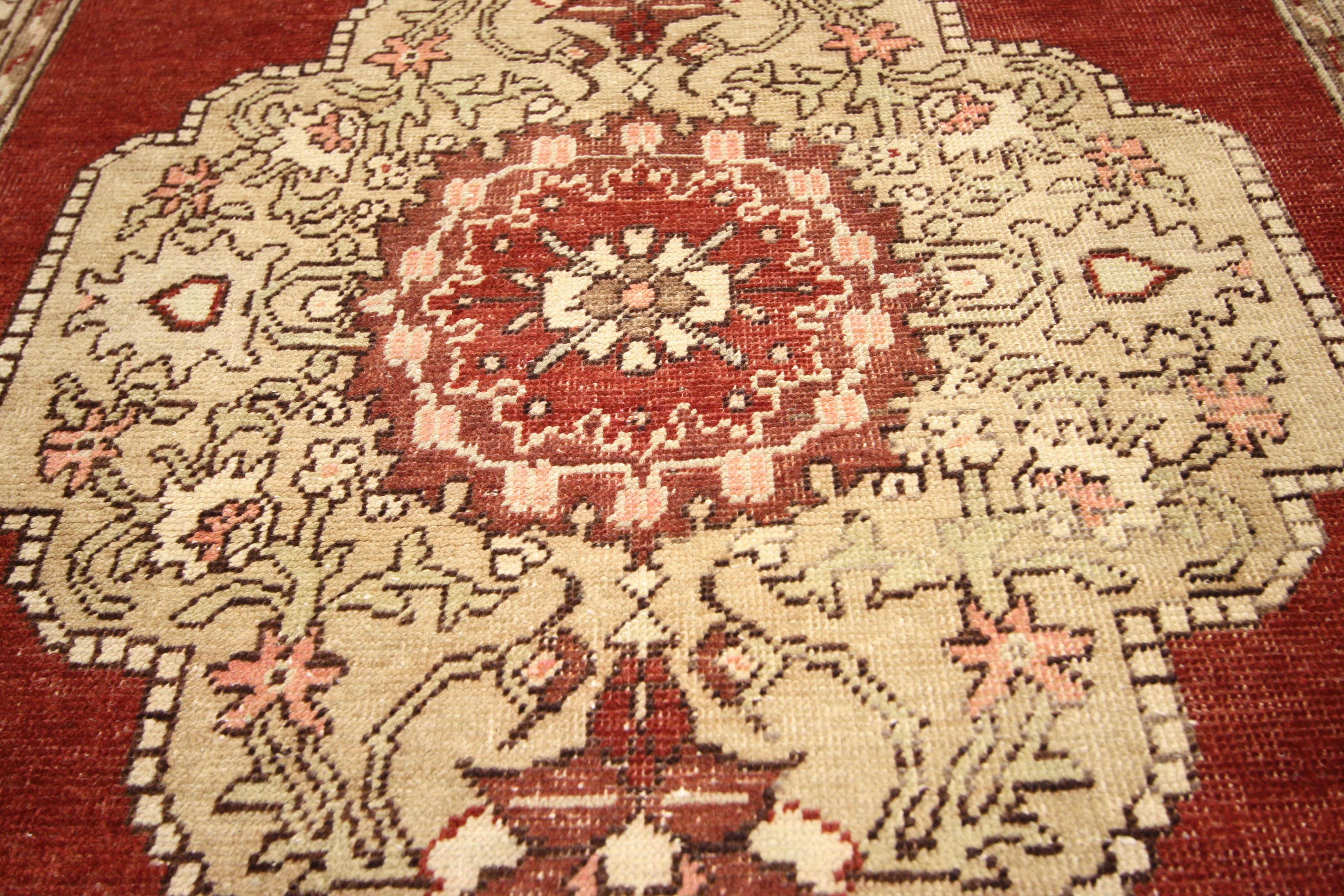 Impressive in style and impeccably woven, this vintage Turkish Oushak carpet runner with modern traditional style features three embellished medallions in an open abrash red field surrounded by an elegant Turkish border. The sophisticated design